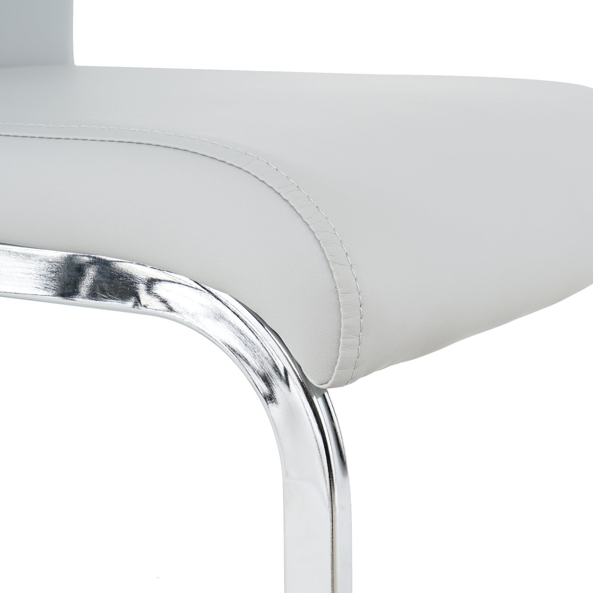 Closeup of a white faux leather bar stool seat with silver stitching and a chrome leg