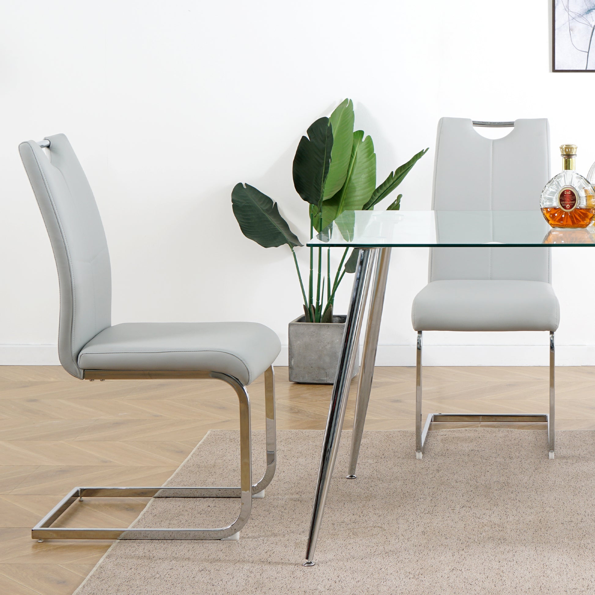 Light gray faux leather dining chair with chrome frame