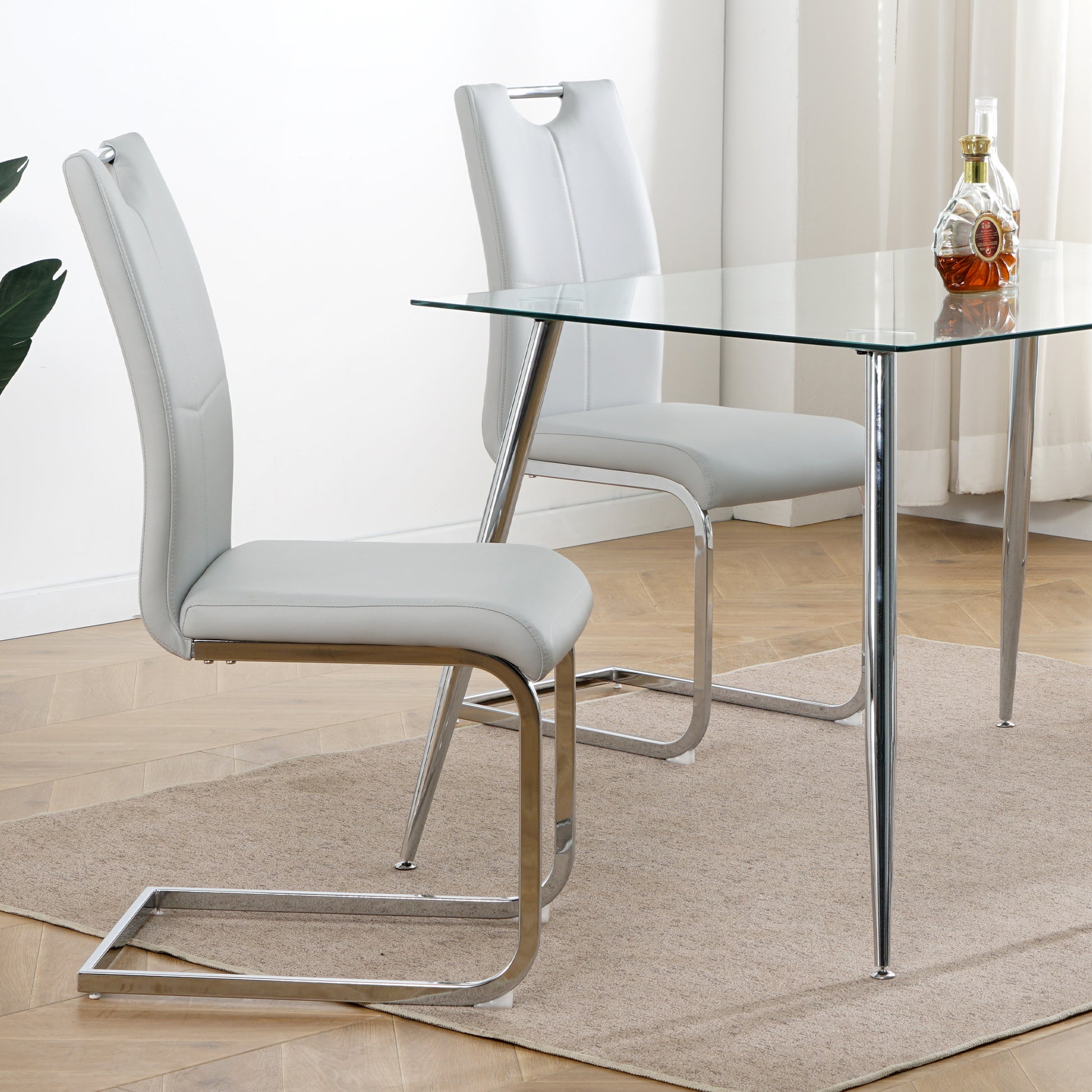 Light grey faux leather dining chair with chrome sled base
