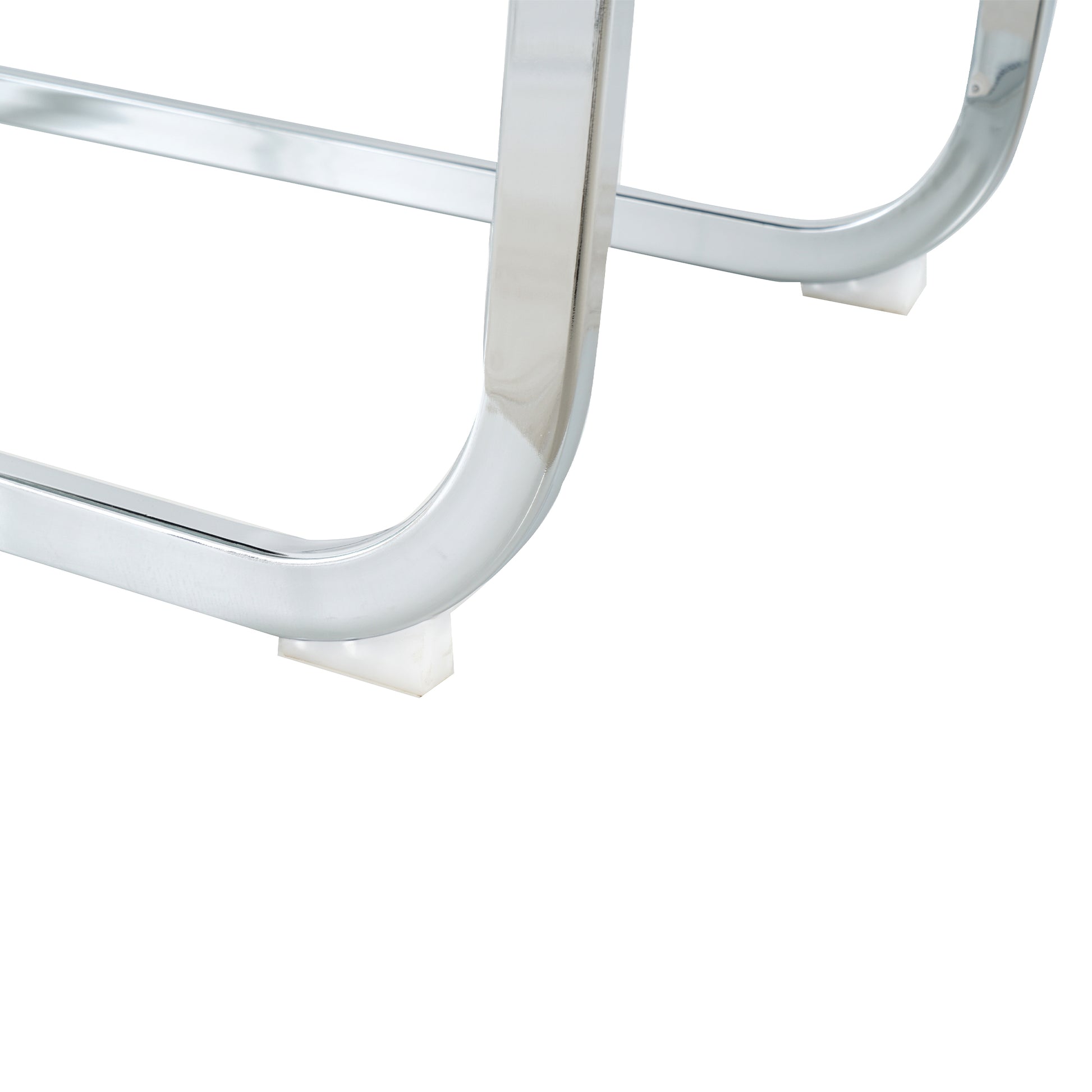 Closeup of curved chrome metal legs with white protective foot caps