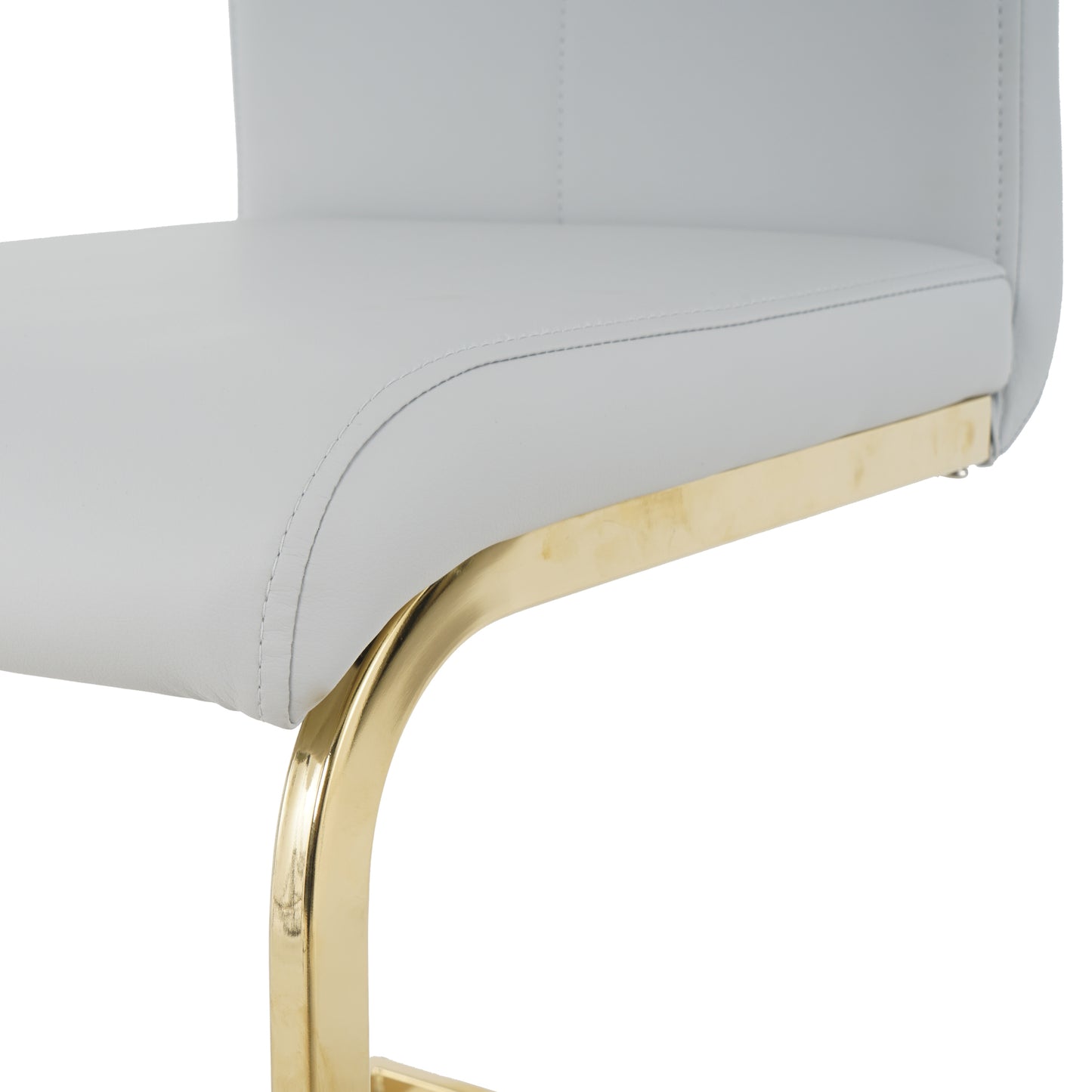 Closeup of a white upholstered bar stool seat with gold metal legs