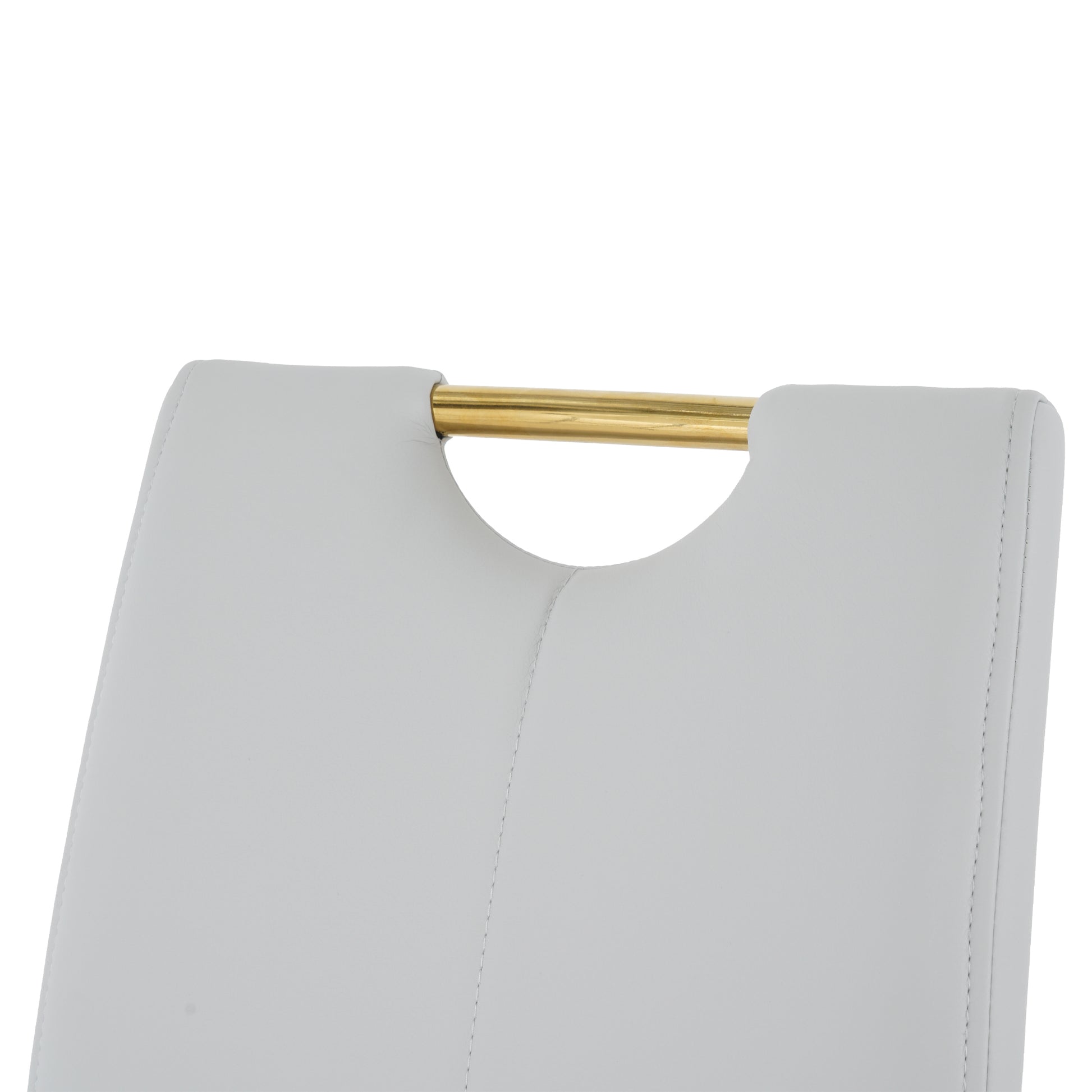 Close up of light gray upholstered chair back with gold metal accent bar