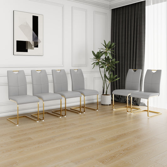 Set of  light grey upholstered dining chairs with gold metal legs