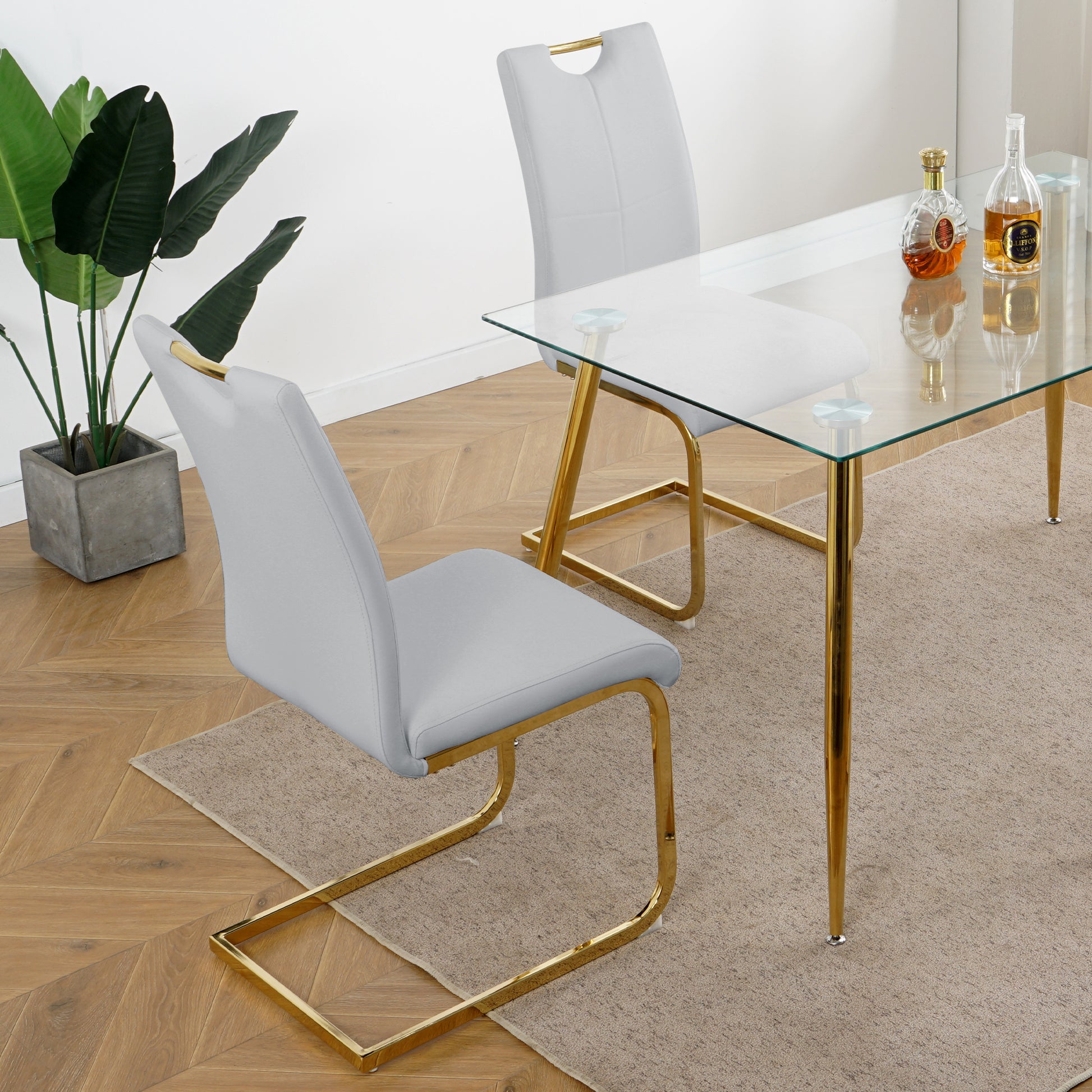 Light gray upholstered dining chair with gold metal sled base
