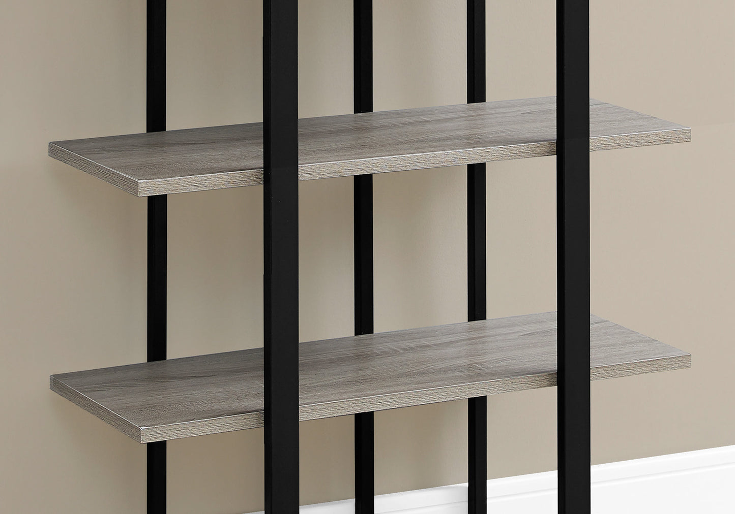 Closeup of a grey wood grain shelf on a black metal bookcase