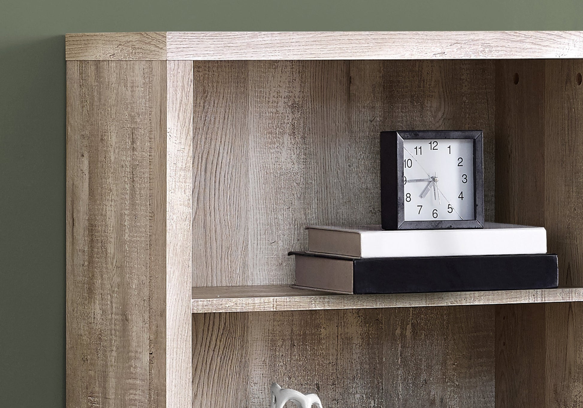 Weathered oak effect bookshelf with two books and a clock