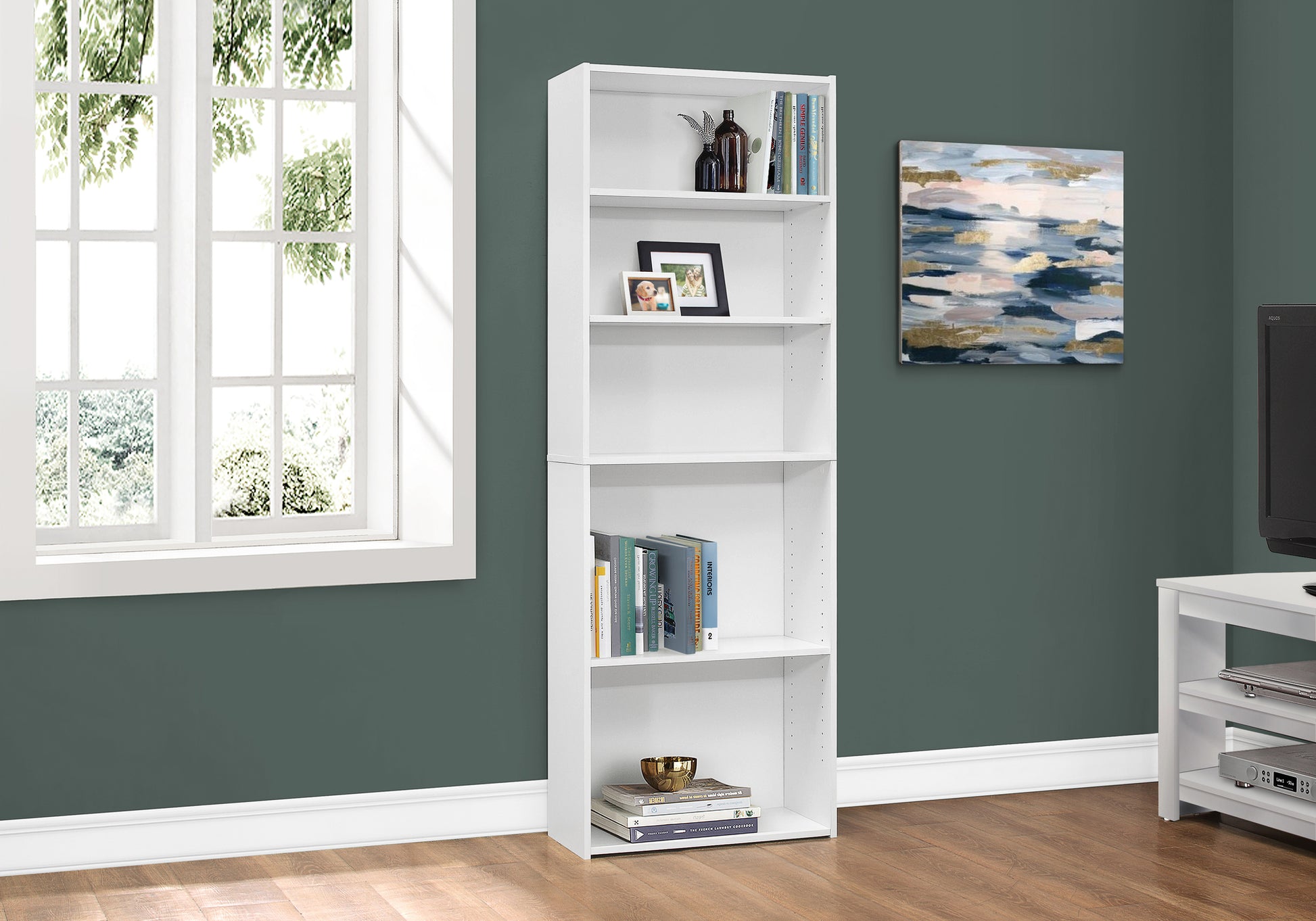 Tall white bookshelf with books and decor