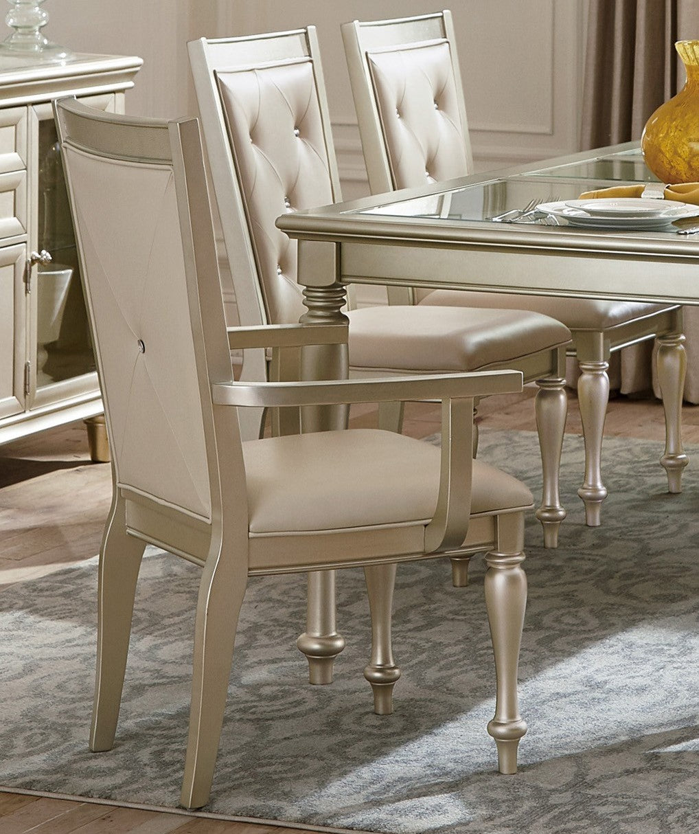 Champagne upholstered dining chair with tufted back and silver frame