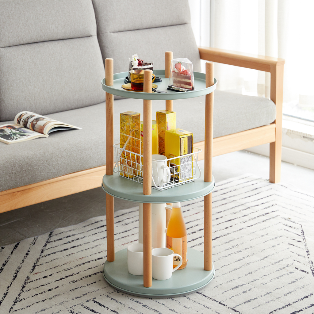 Pale mint threetier accent table with wooden legs displaying snacks and drinks