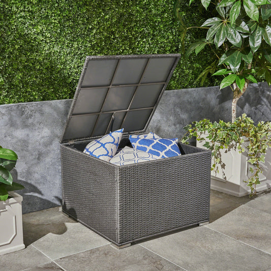 Gray wicker outdoor storage box with blue patterned cushions ideal for patio furniture storage