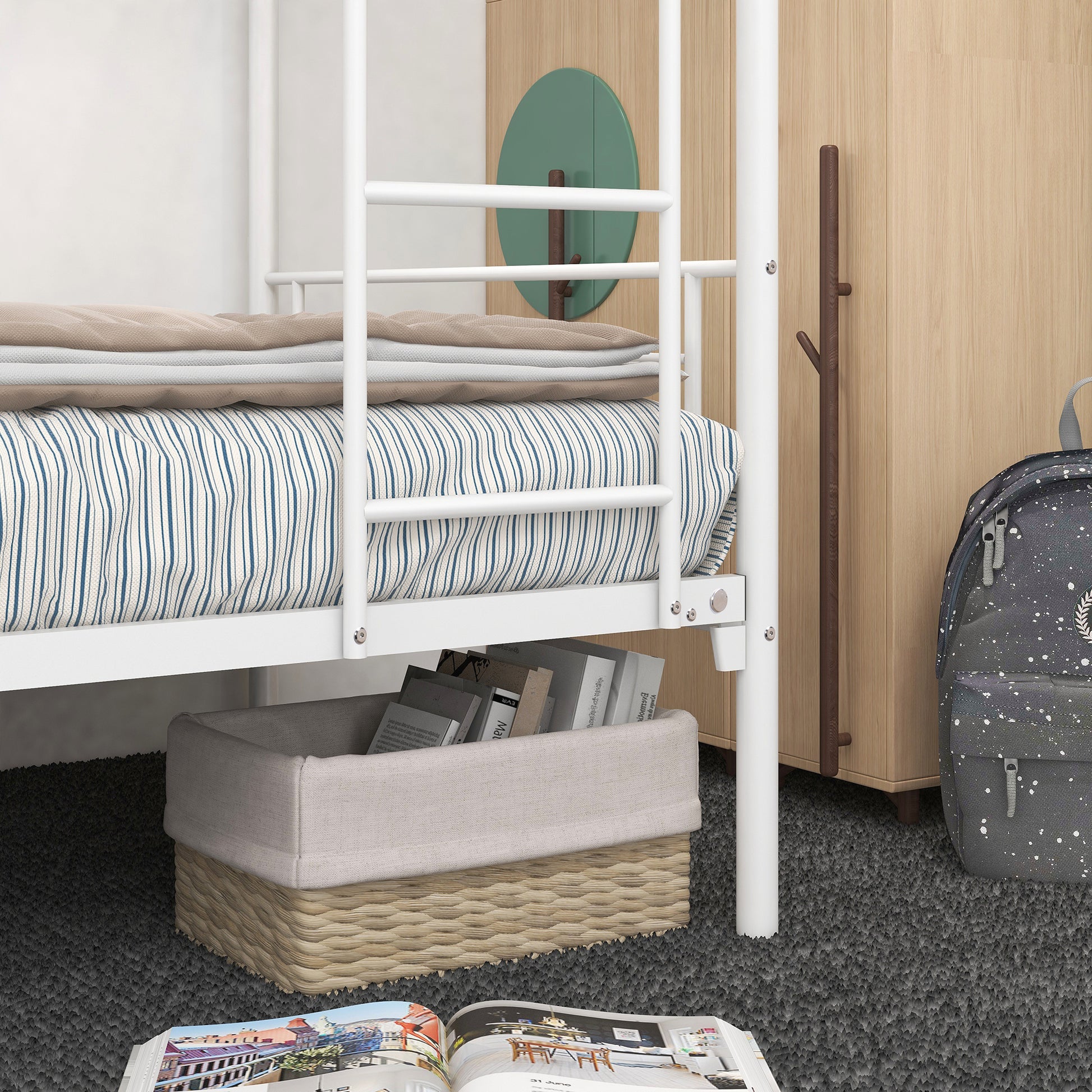 White metal bunk bed with striped bedding and storage basket