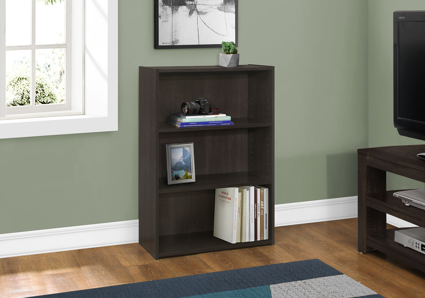 Dark brown wood veneer shelf bookcase with books and camera