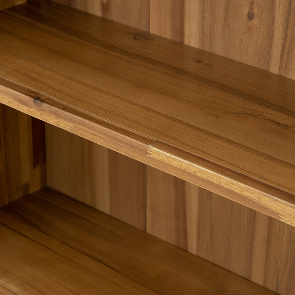 Closeup of a warm honeytoned wood bookshelf with visible grain patterns