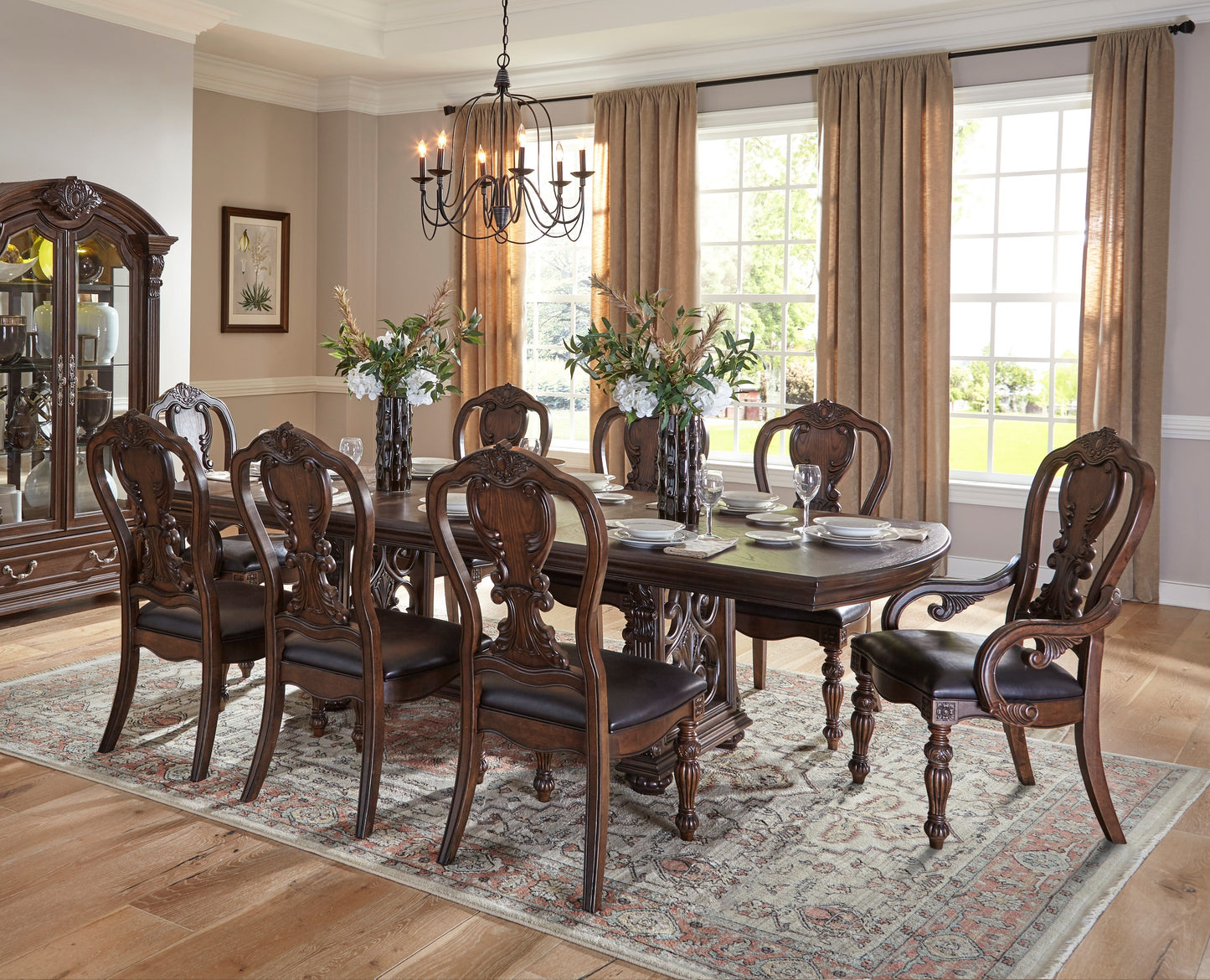 Ornate mahogany dining table with carved details and upholstered chairs