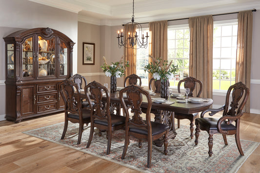 Ornate dark wood dining room buffet with glass doors and detailed carvings