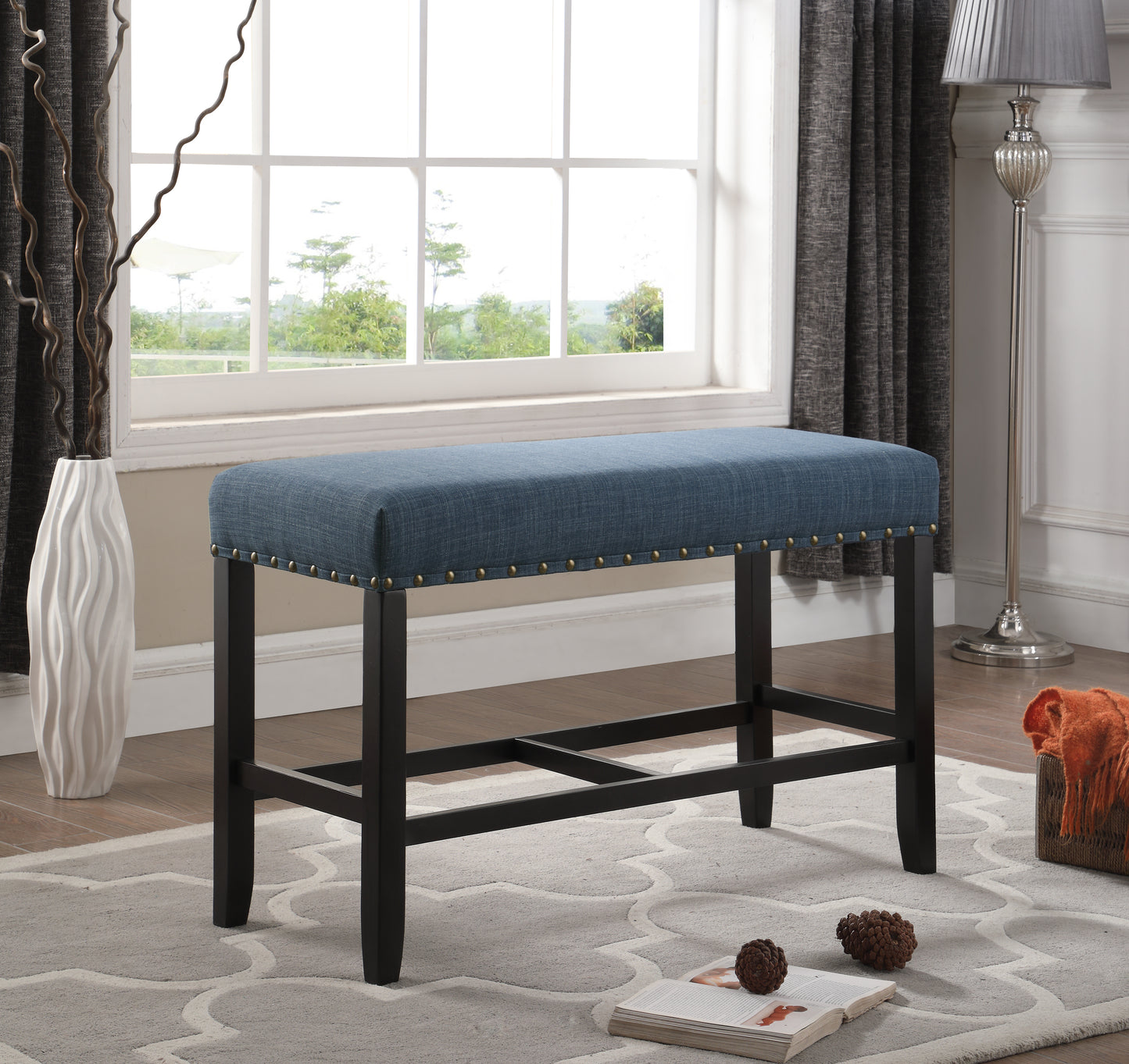 Tufted blue linen bench with brass nailhead trim