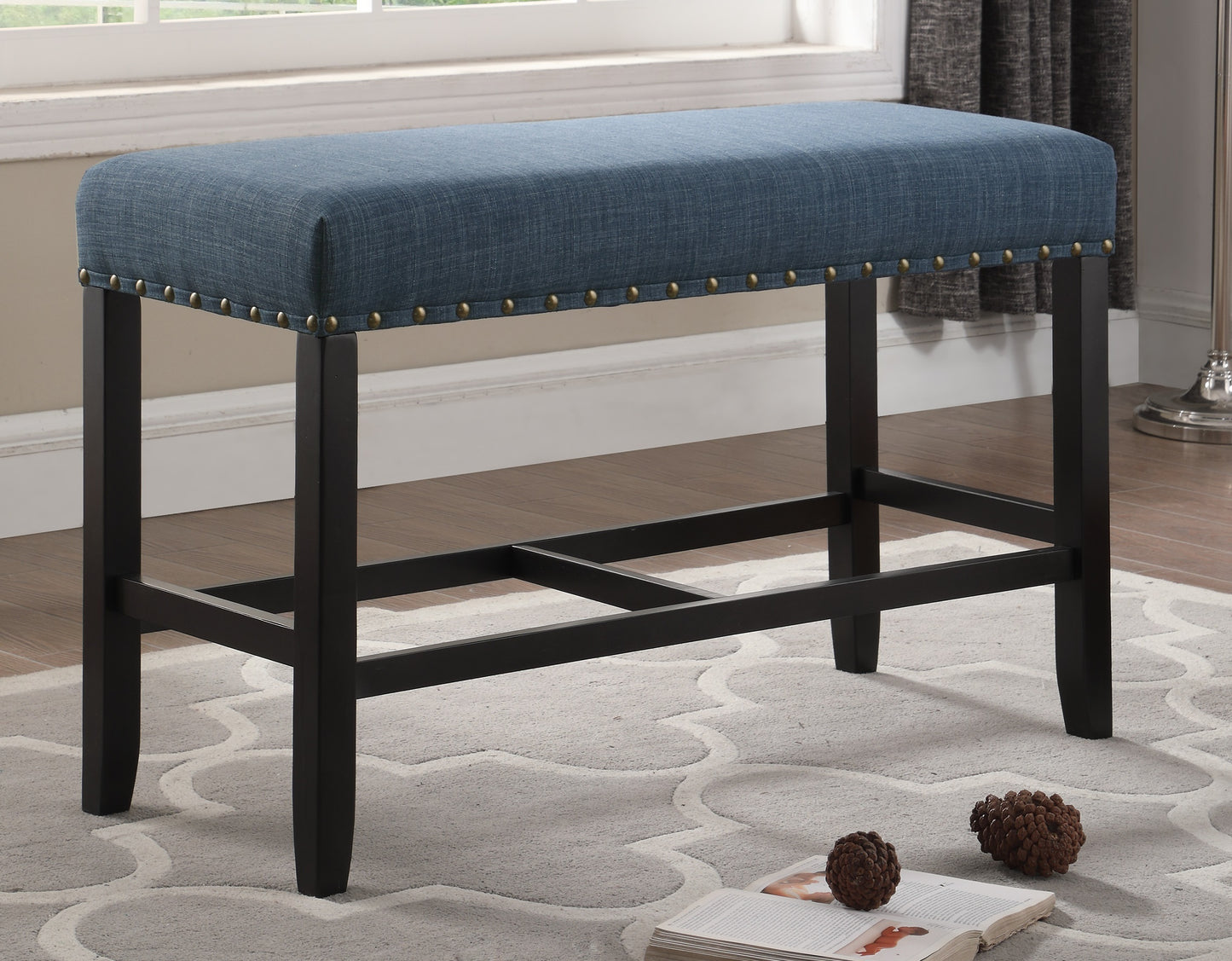 Blue upholstered dining bench with nailhead trim and dark wood legs