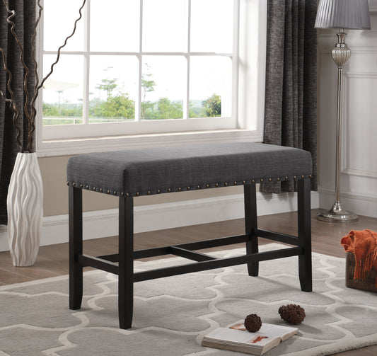 Dark gray upholstered counter stool with nailhead trim and dark wood legs