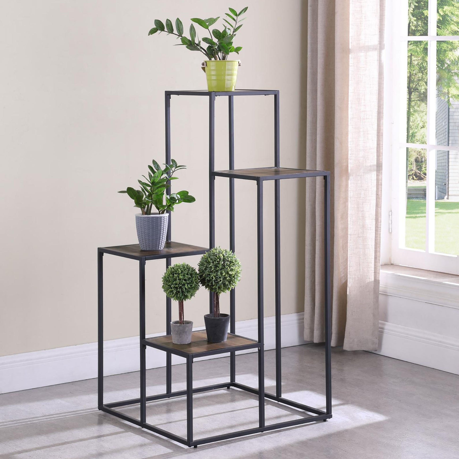 Metal plant stand with tiered shelves holding potted plants