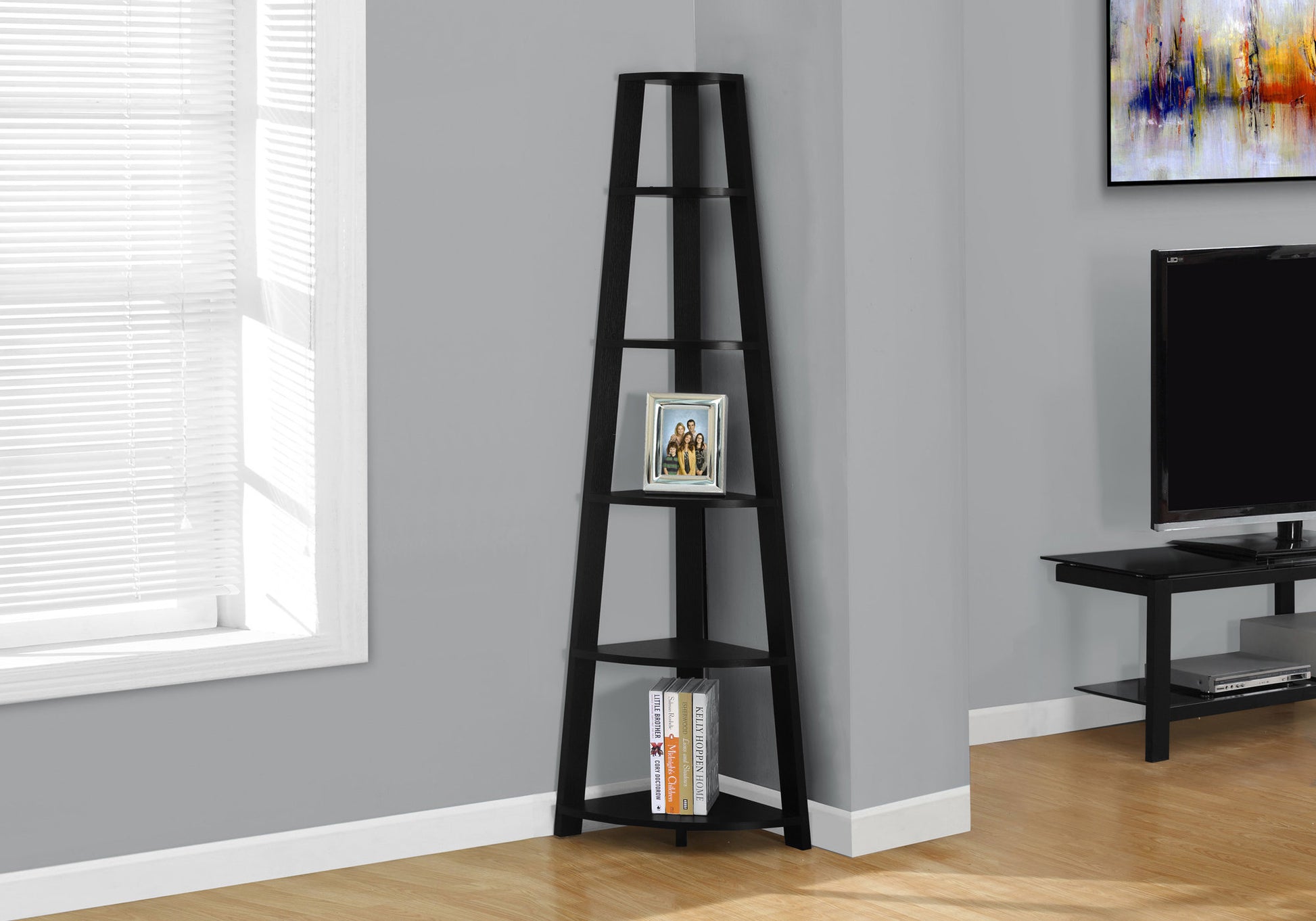 Black wooden corner shelf with  tiers and decorative picture frame