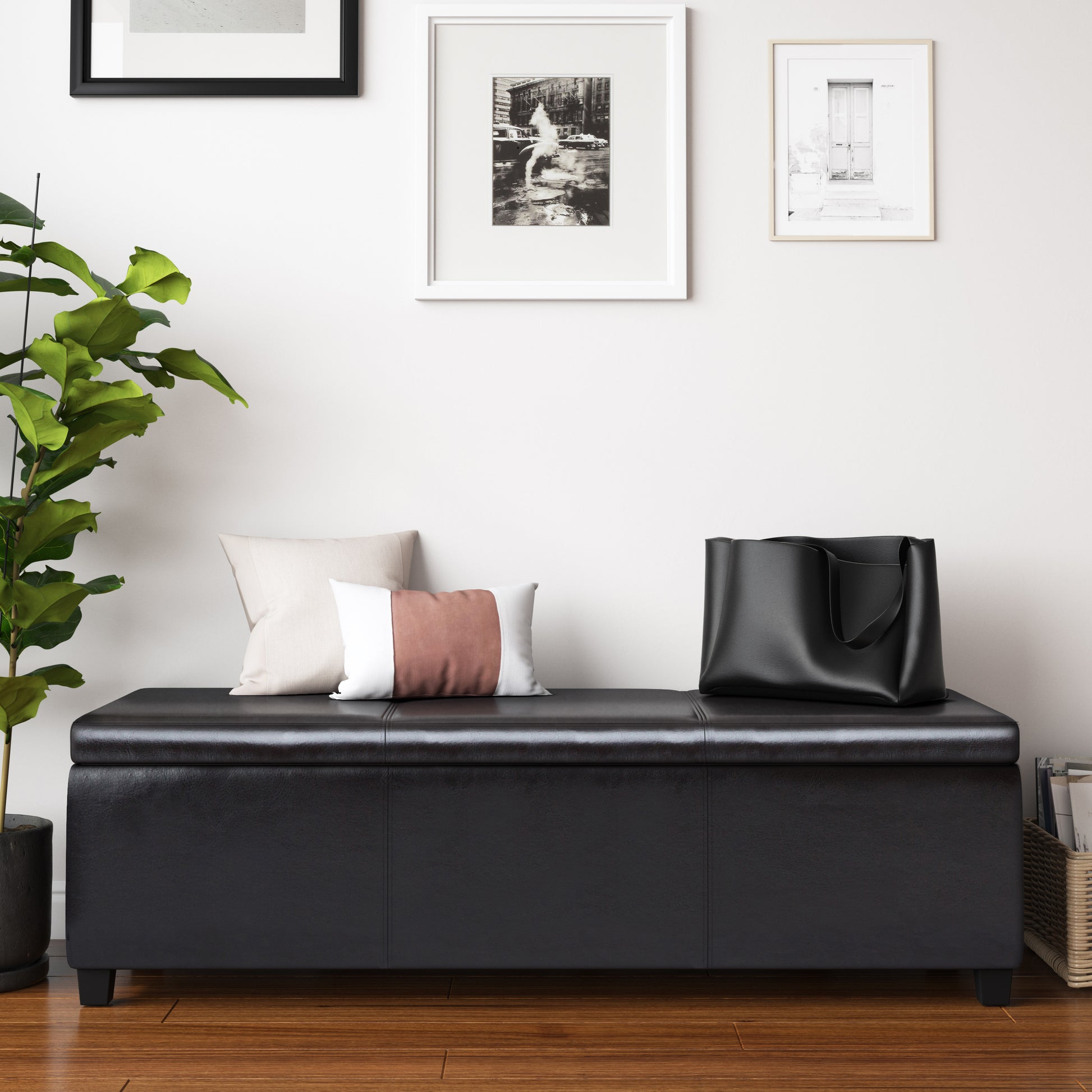 Black faux leather storage ottoman with plush pillows and tote bag