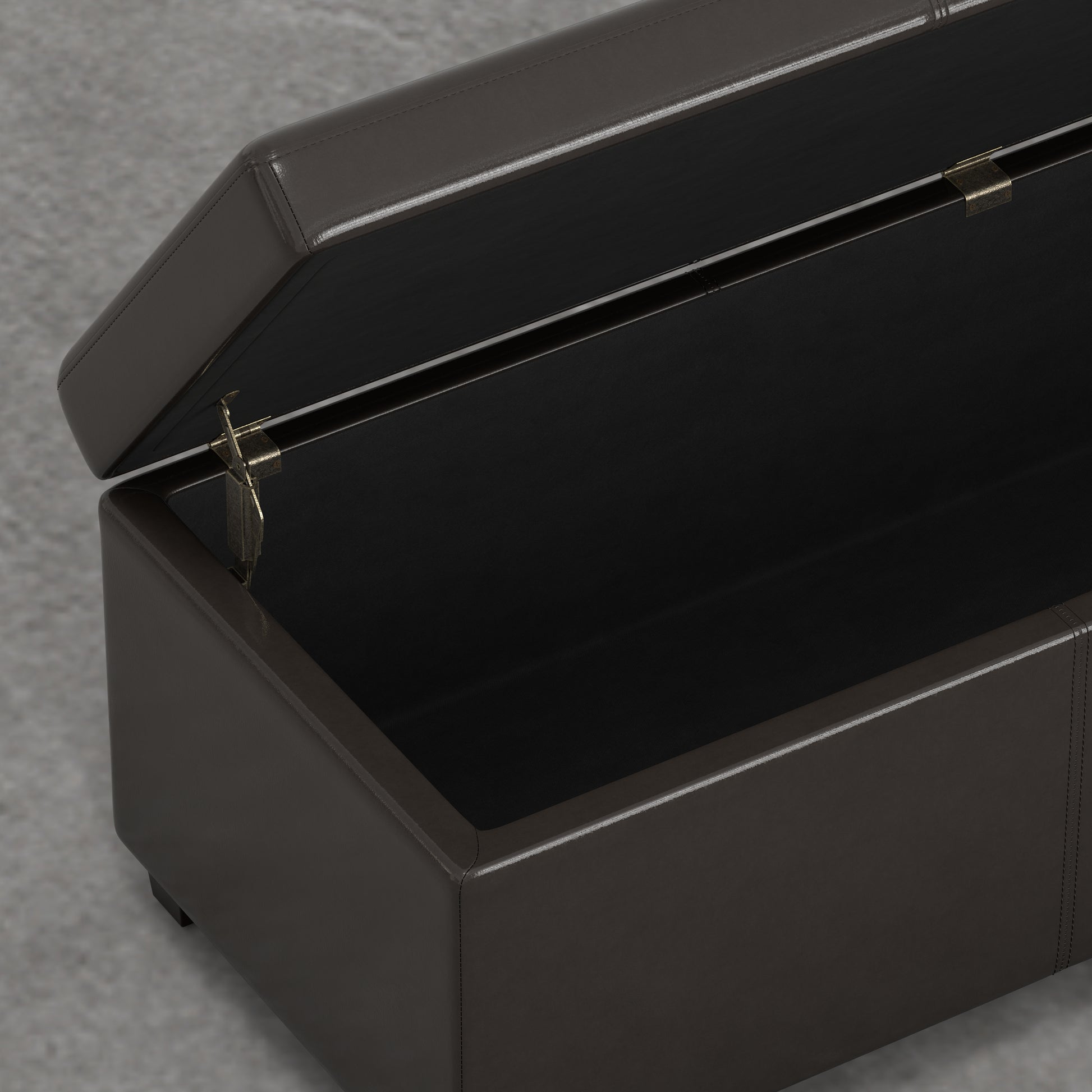 Brown faux leather storage ottoman with open lid revealing black interior