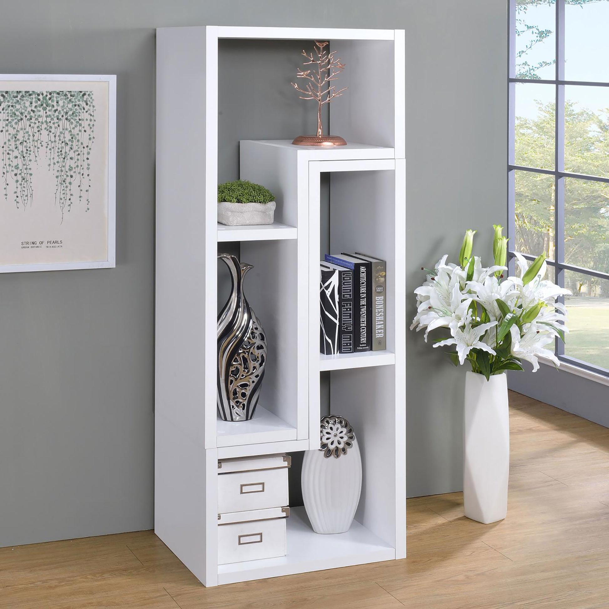 Modern white bookshelf with asymmetric shelves and decorative items