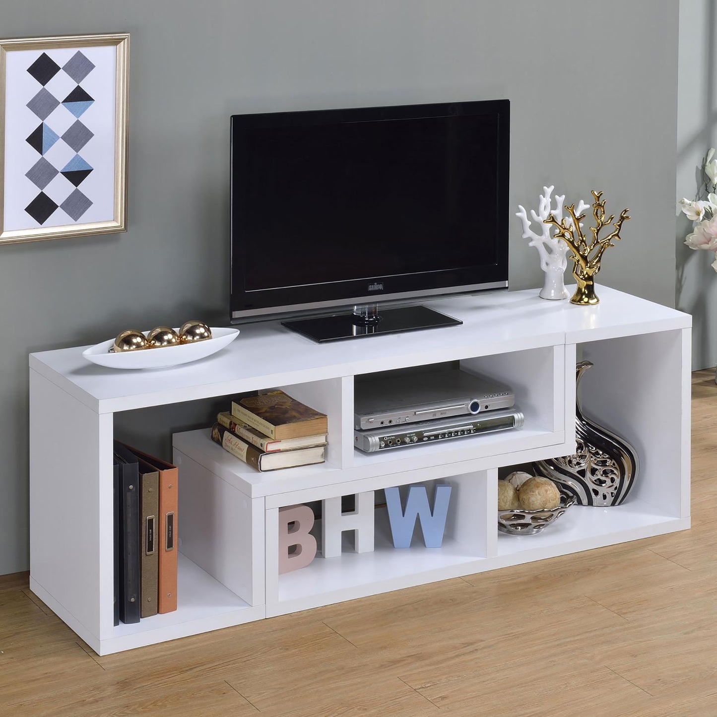 Modern white media console with TV and decorative items