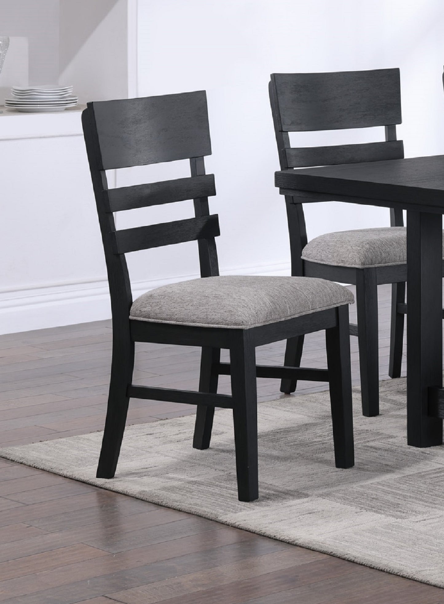 Black wooden dining chair with grey upholstered seat and ladder back design