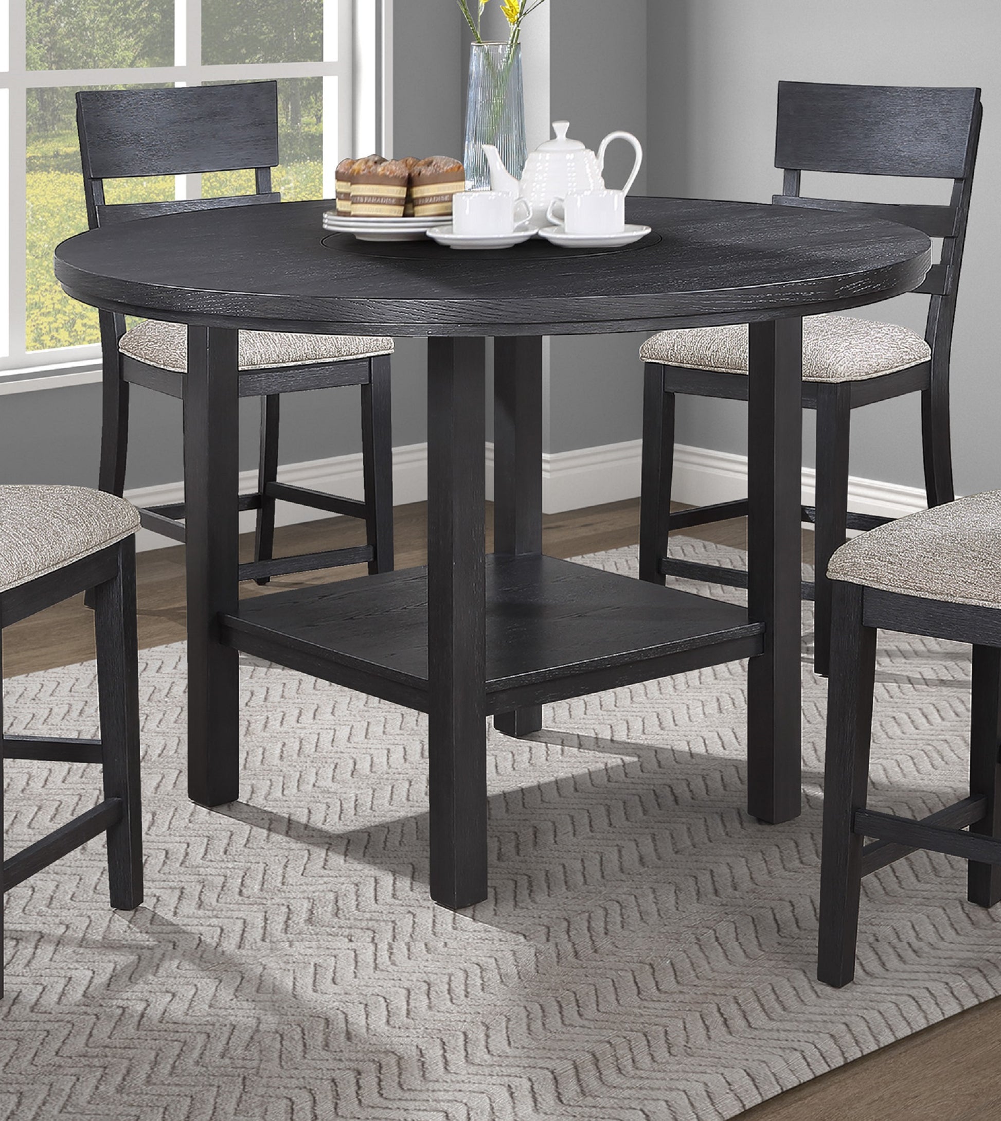 Dark gray round counterheight dining table with wood grain texture and four matching stools