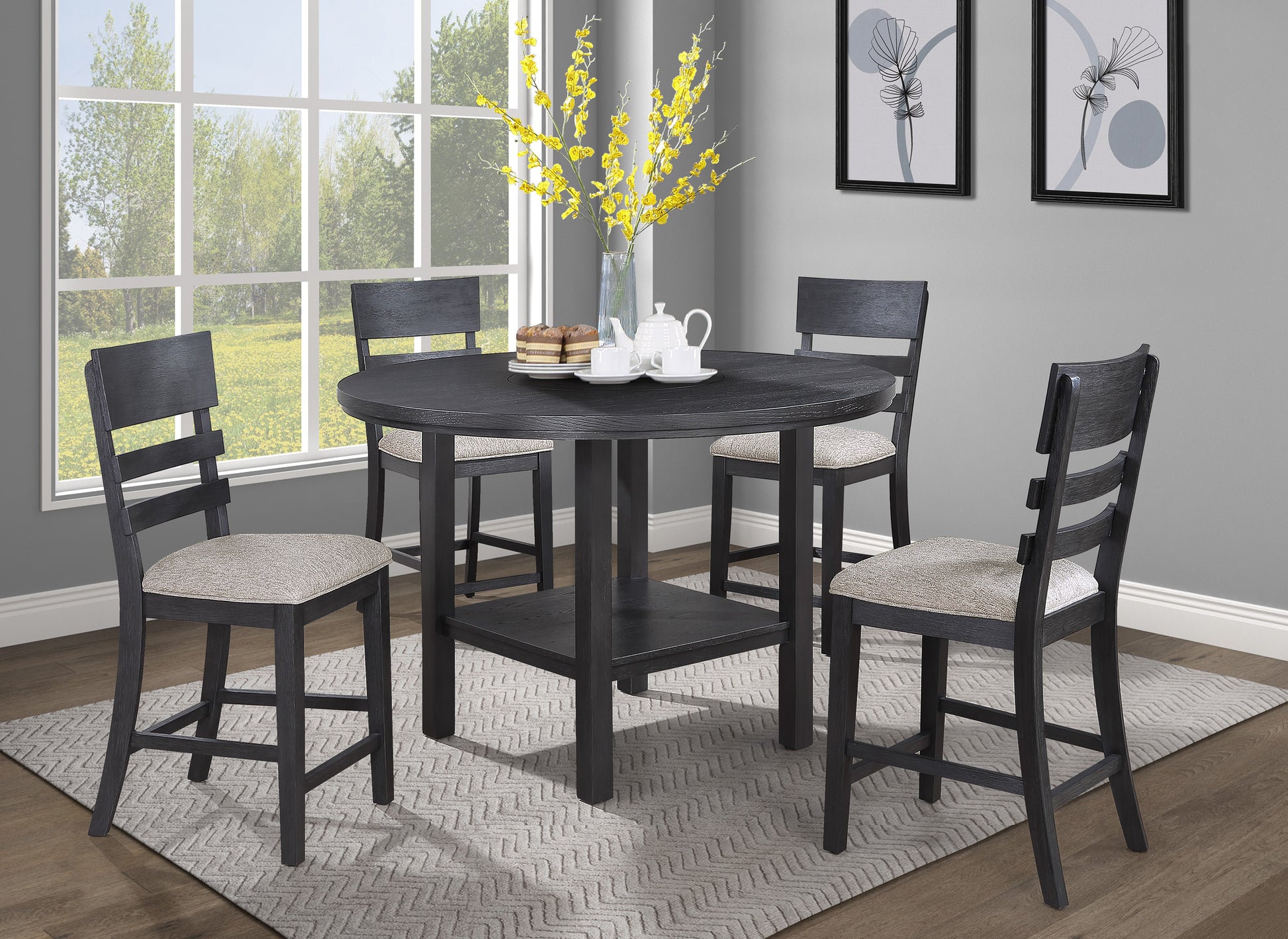 Black round counter height dining table with four upholstered chairs and a shelf