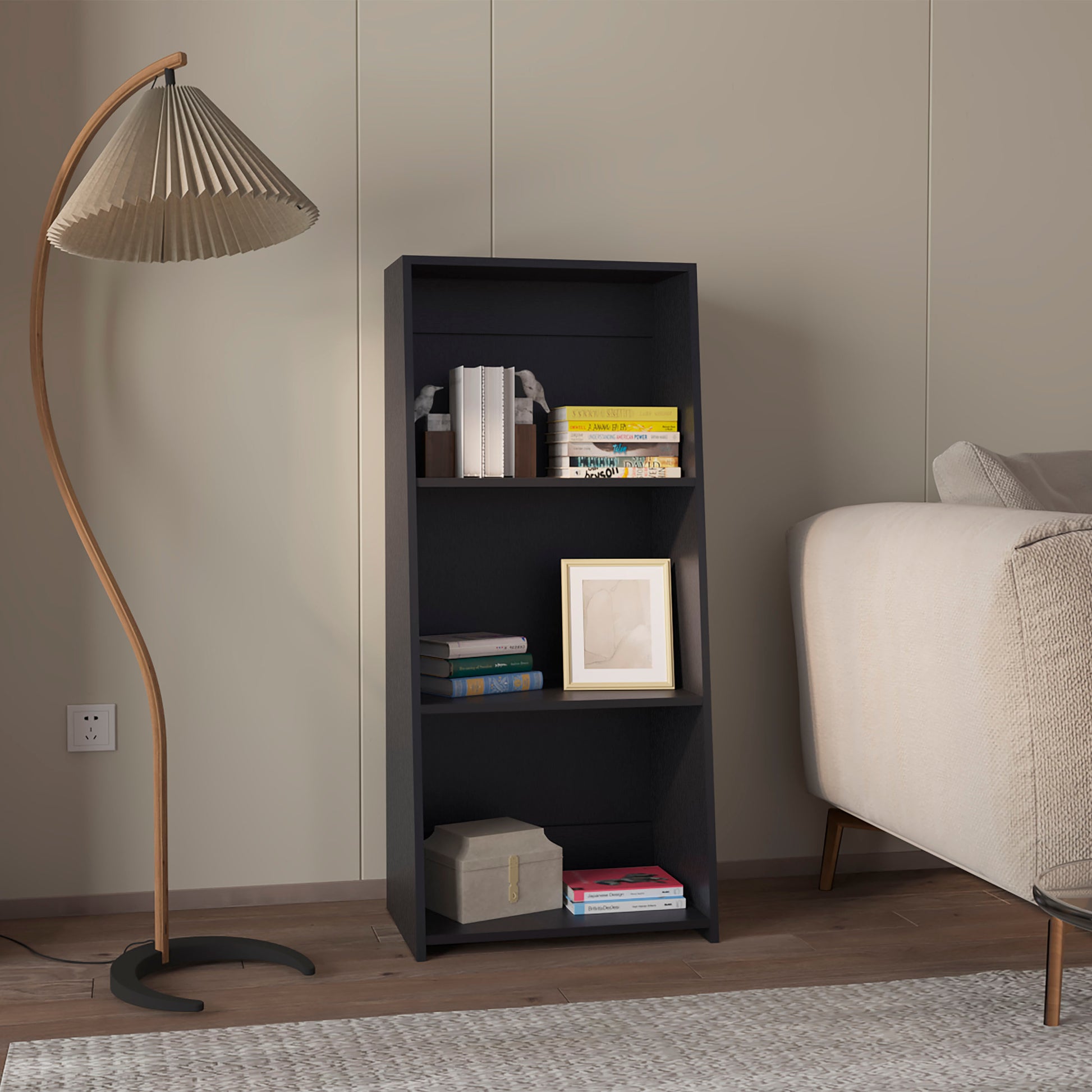 Dark grey modern bookshelf with three shelves holding books and decor
