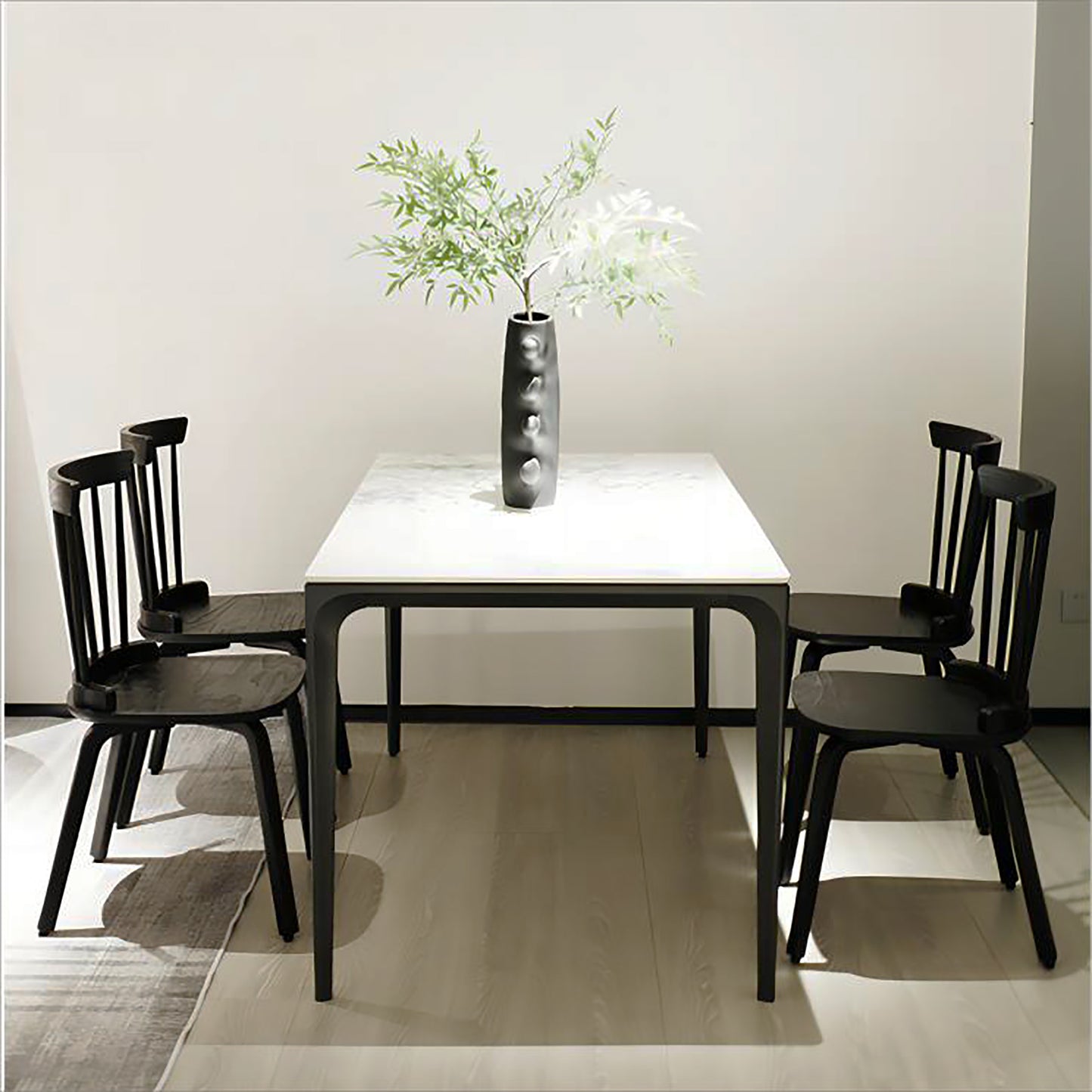 Modern marble top dining table with four black chairs