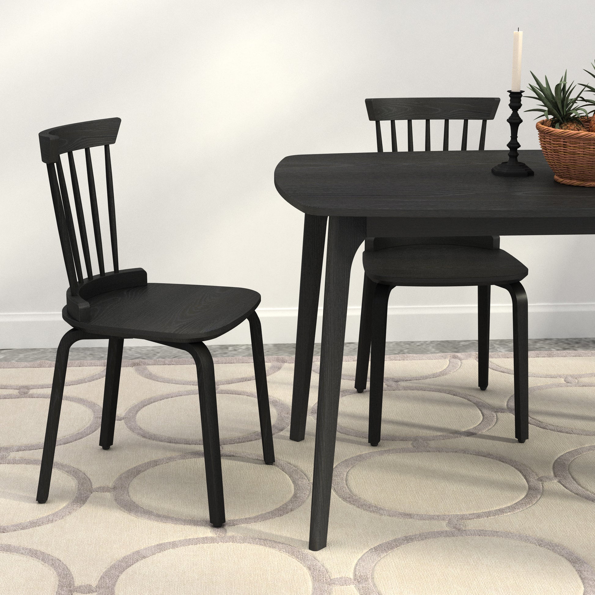 Black wooden dining chair with spindle back and curved seat
