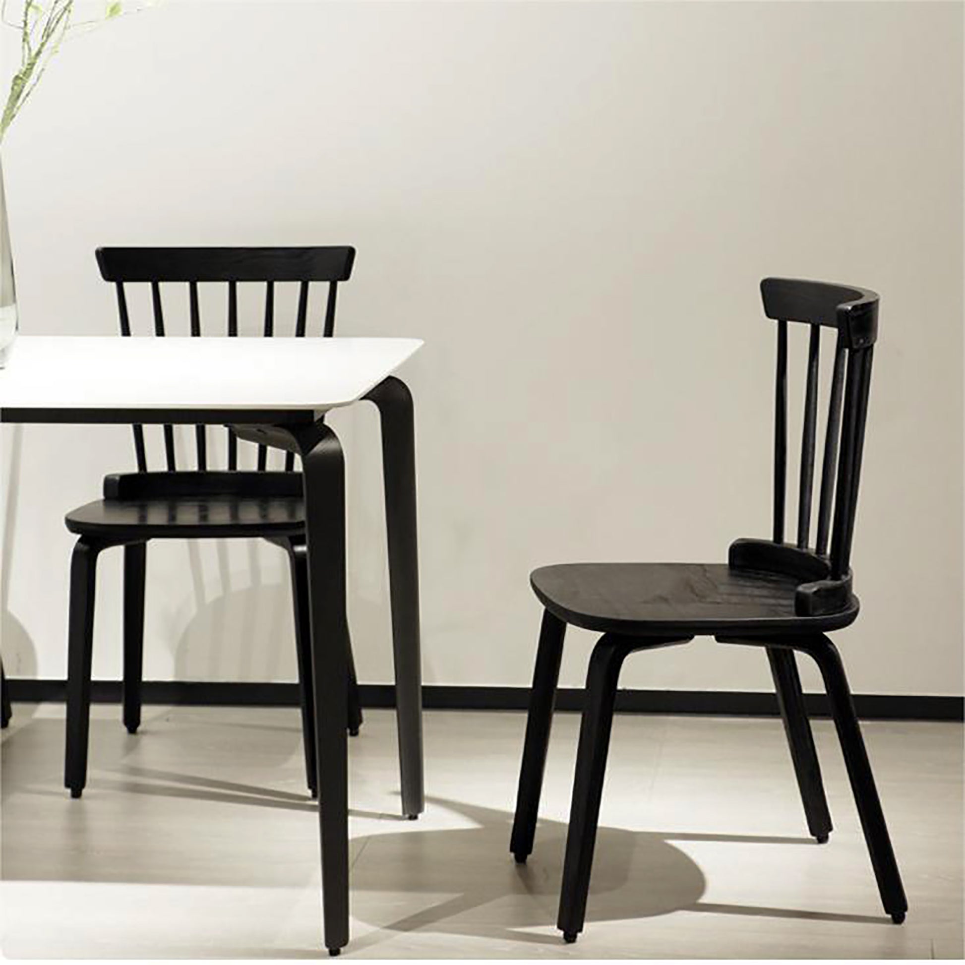 Black wooden spindle back chair with a curved seat