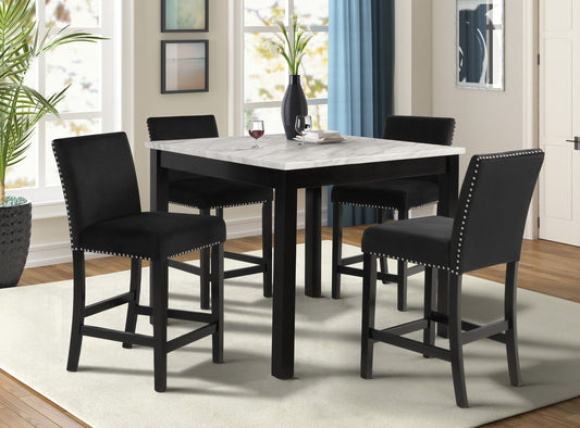 Black velvet bar stools with silver nailhead trim surrounding a white marble pub table