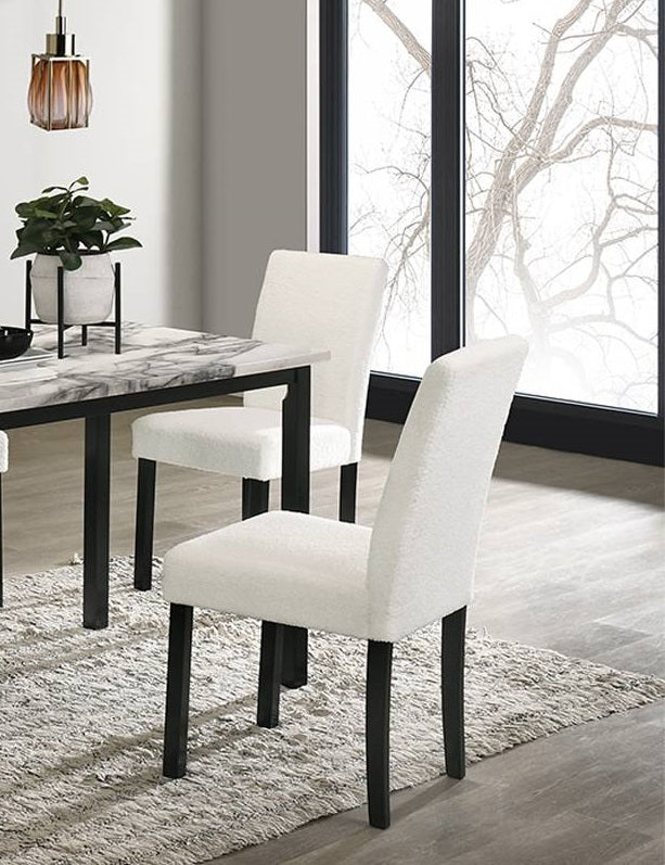 Plush white dining chair with sleek black legs a modern addition to any home