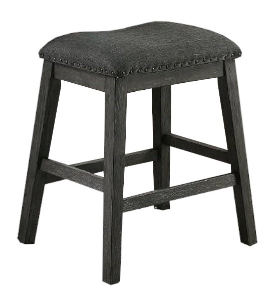 Dark gray upholstered backless bar stool with distressed wood legs and nailhead trim