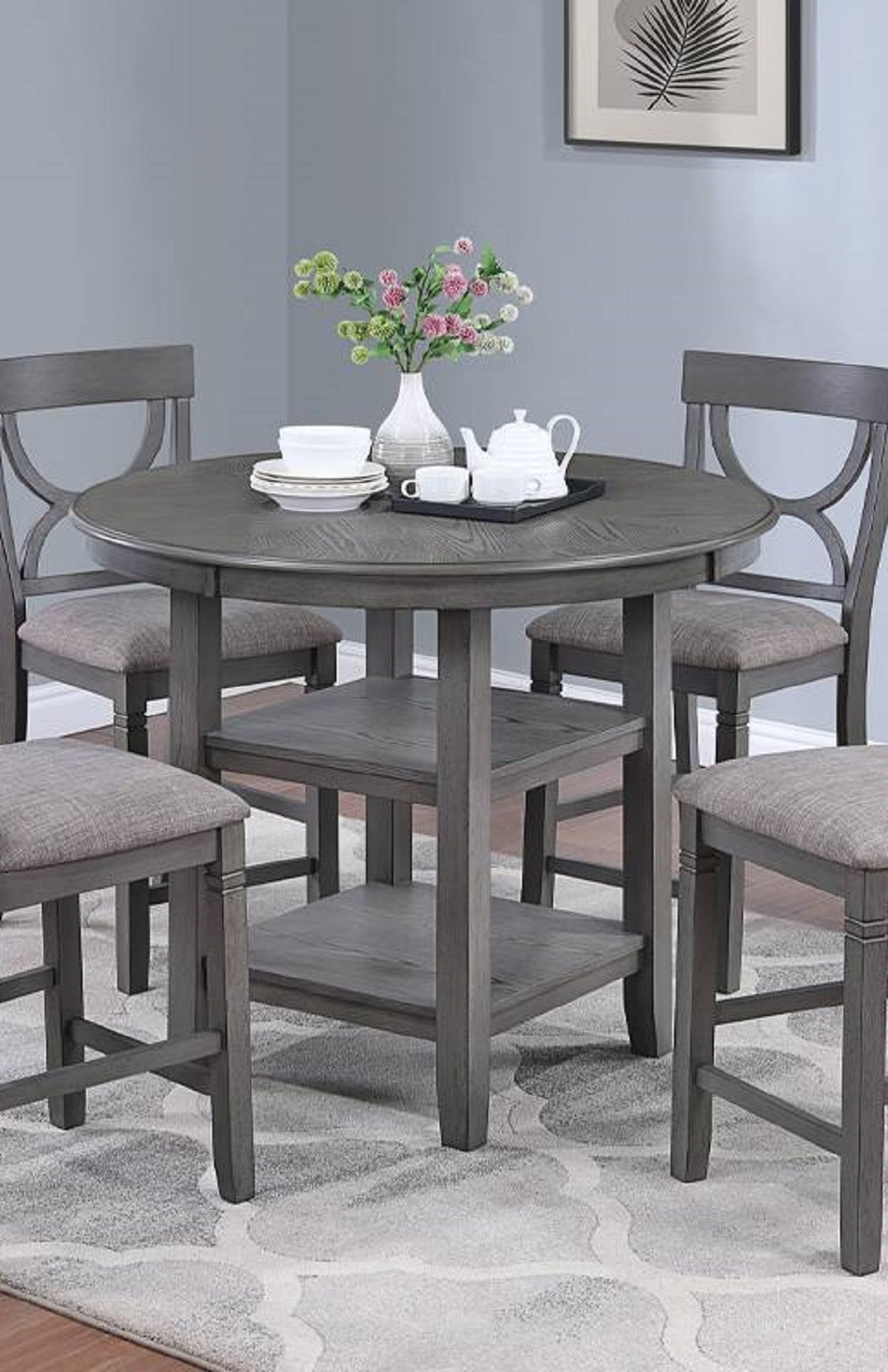 Gray round counter height table with four upholstered stools