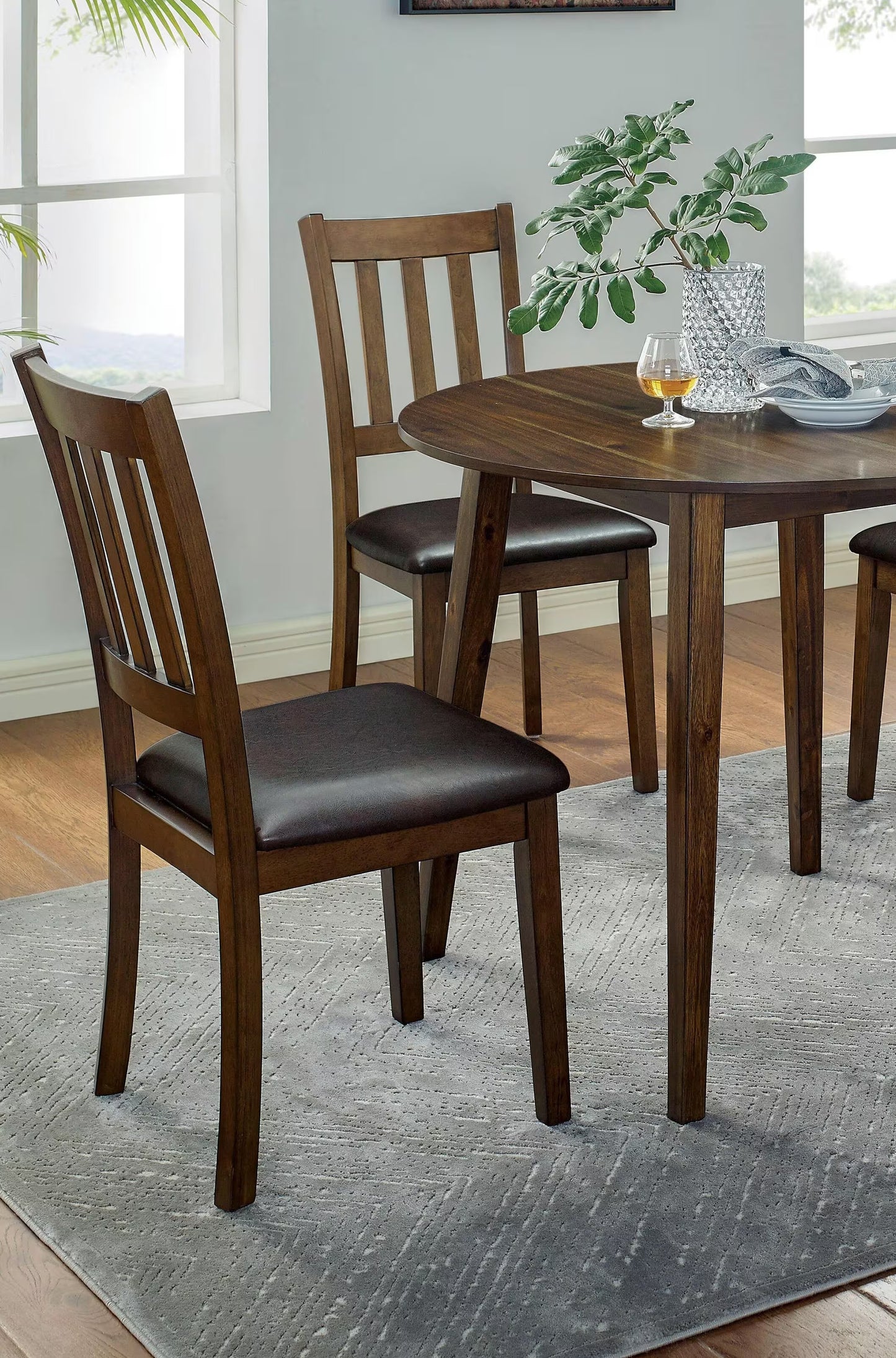 Dark wood dining chair with brown upholstered seat