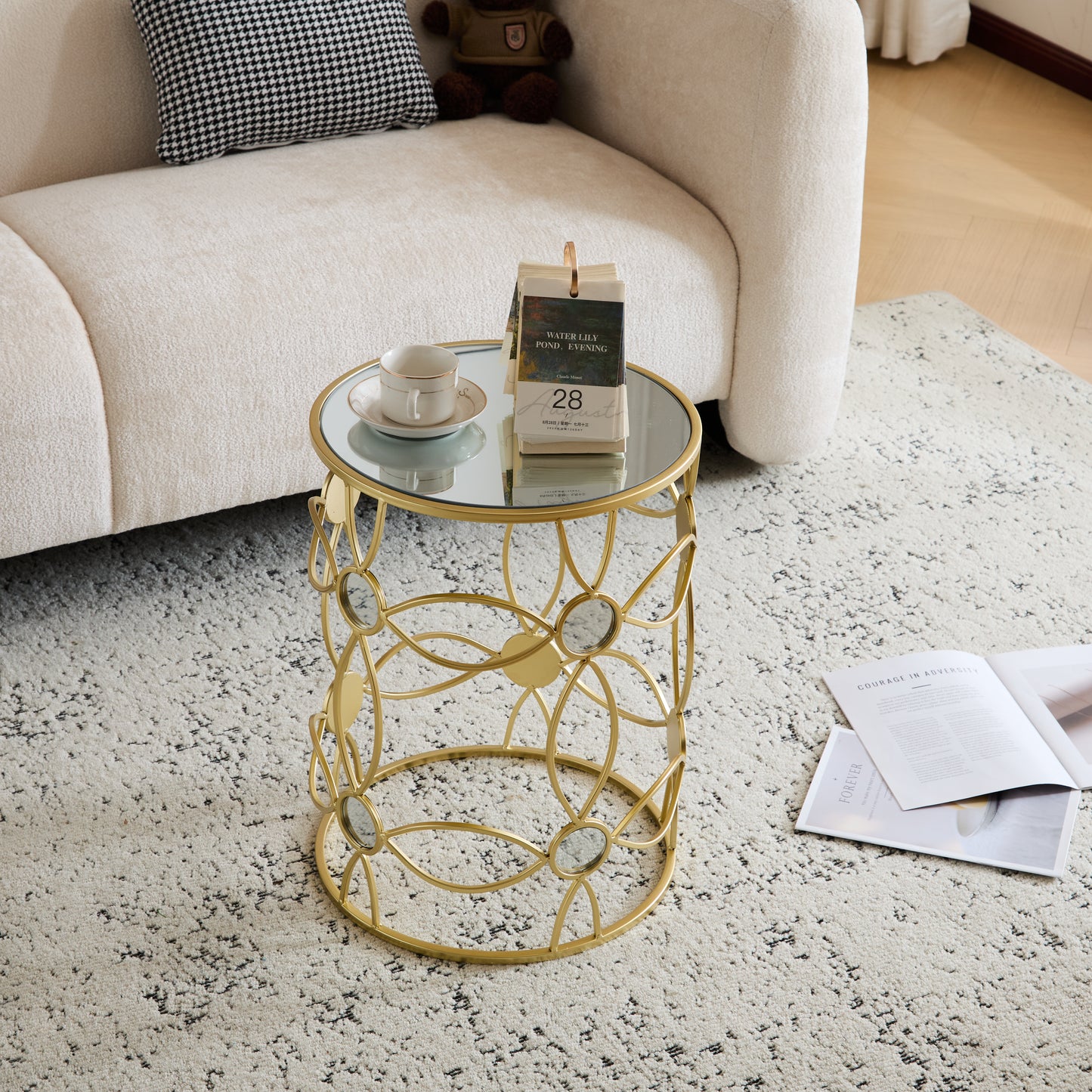Gold accent end table with mirrored top and intricate metal base