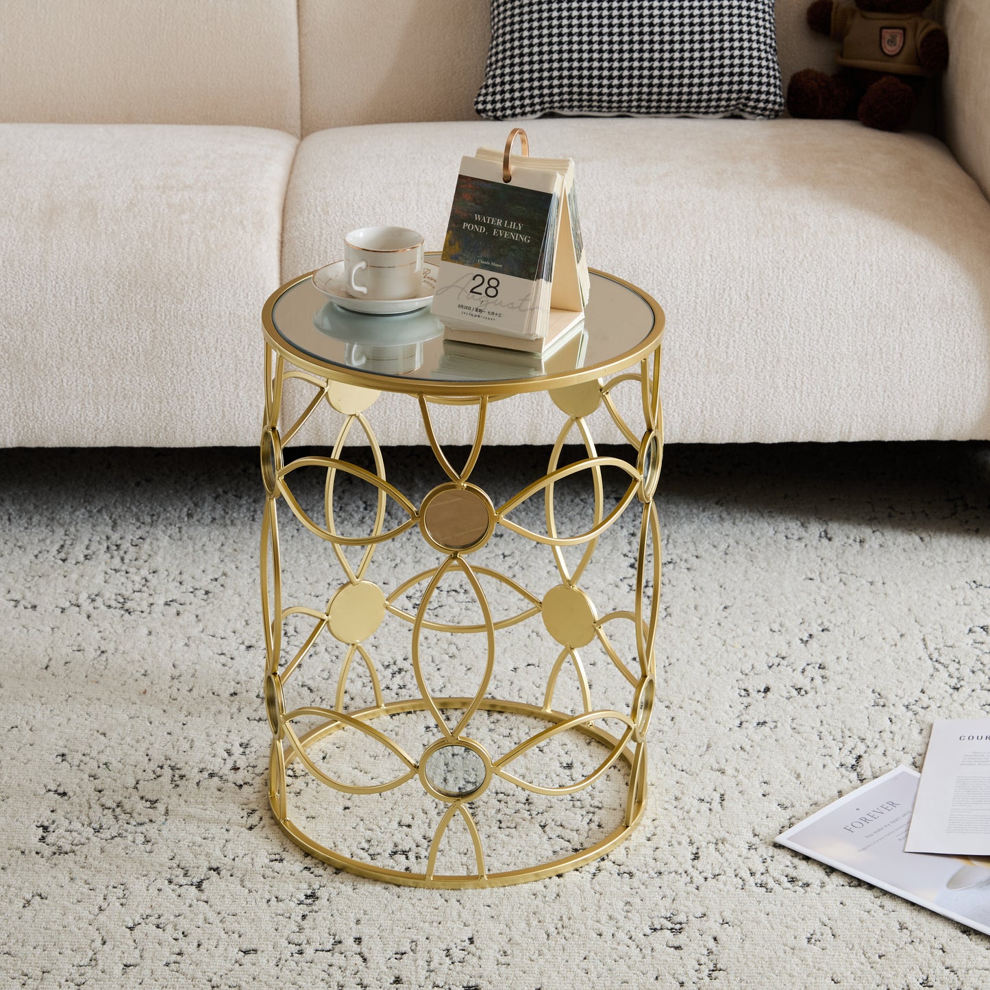 Gold metal side table with mirrored top and intricate geometric base