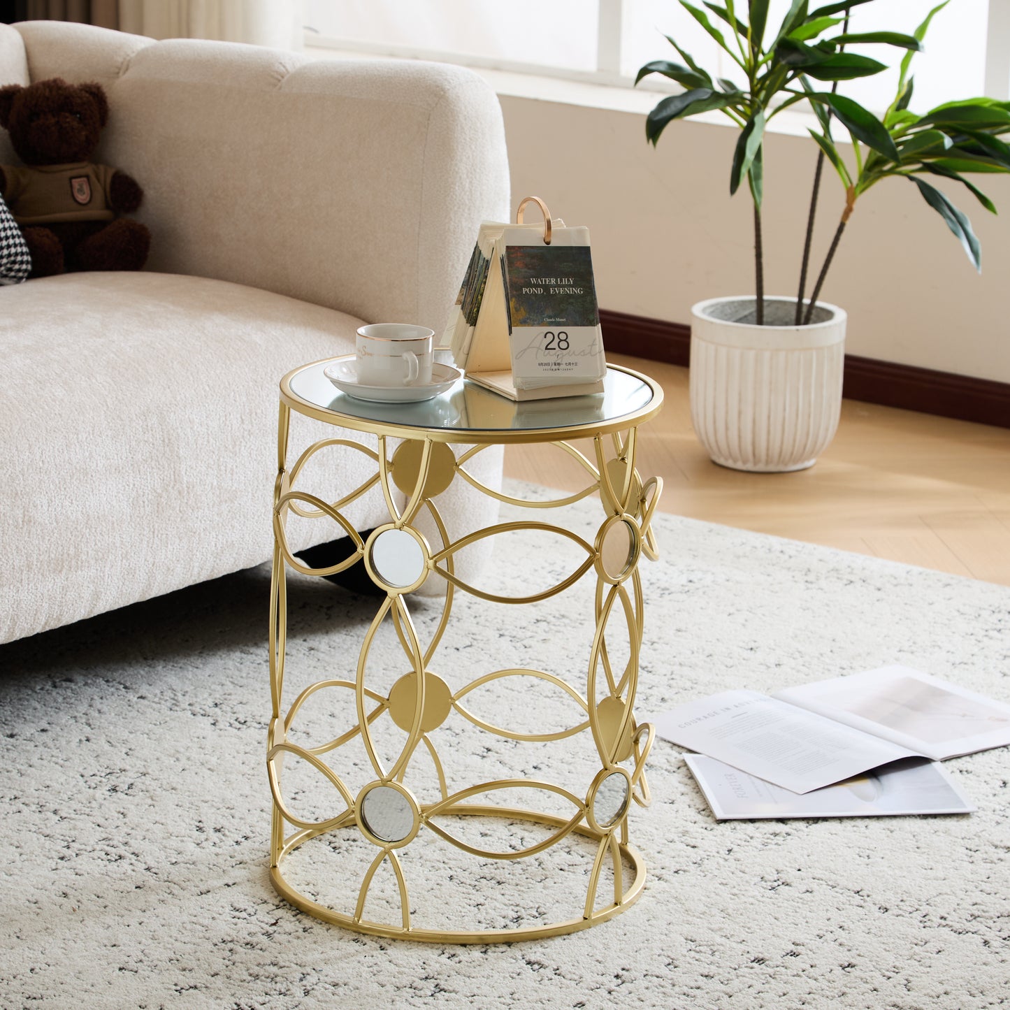 Gold metal side table with glass top and mirrored accents
