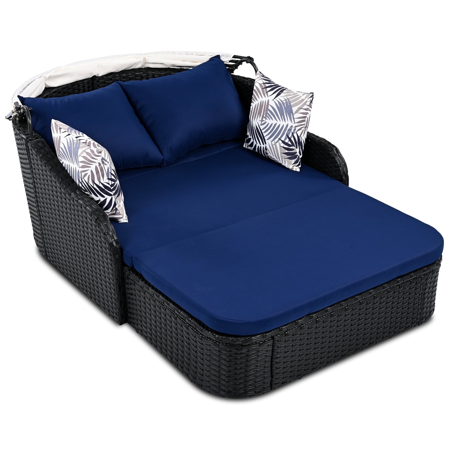 Black wicker daybed with navy cushions and palm leaf accent pillows for outdoor relaxation