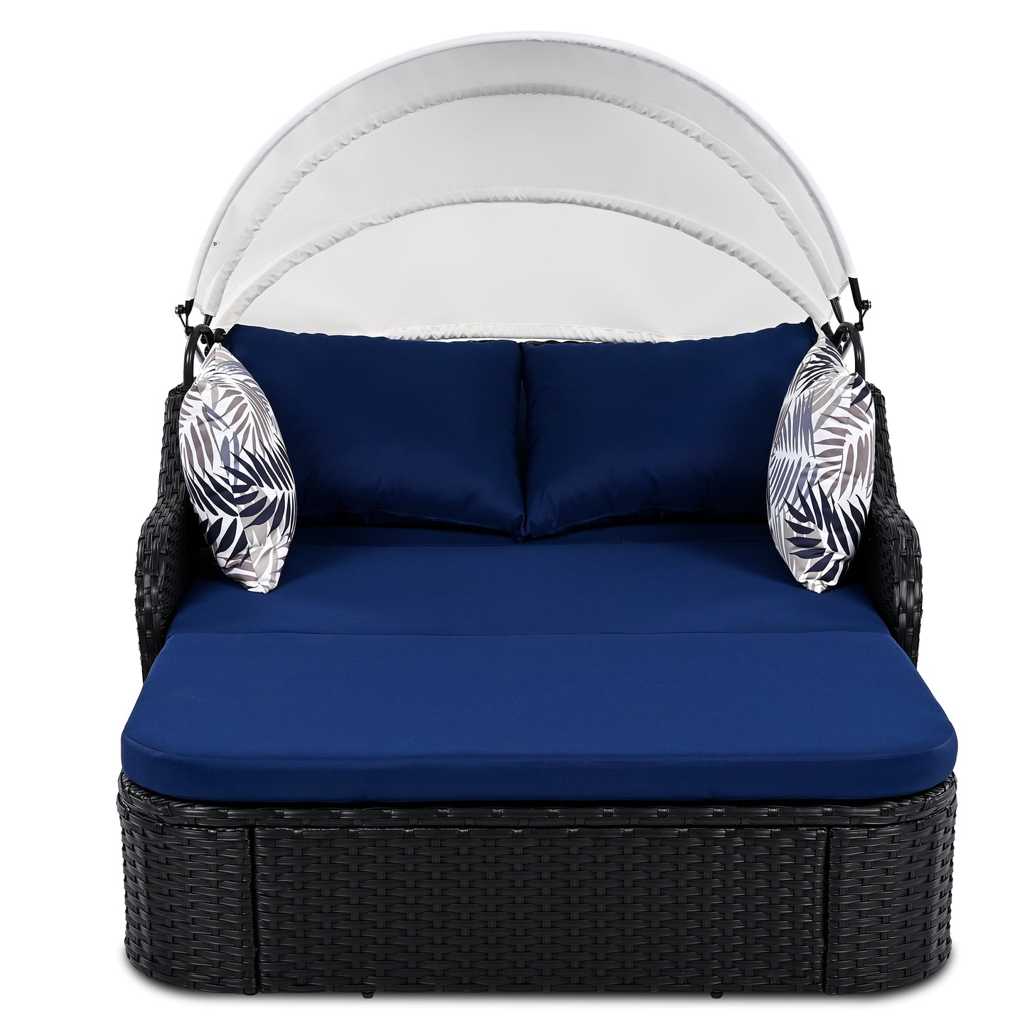 Black rattan outdoor daybed with navy blue cushions and white canopy
