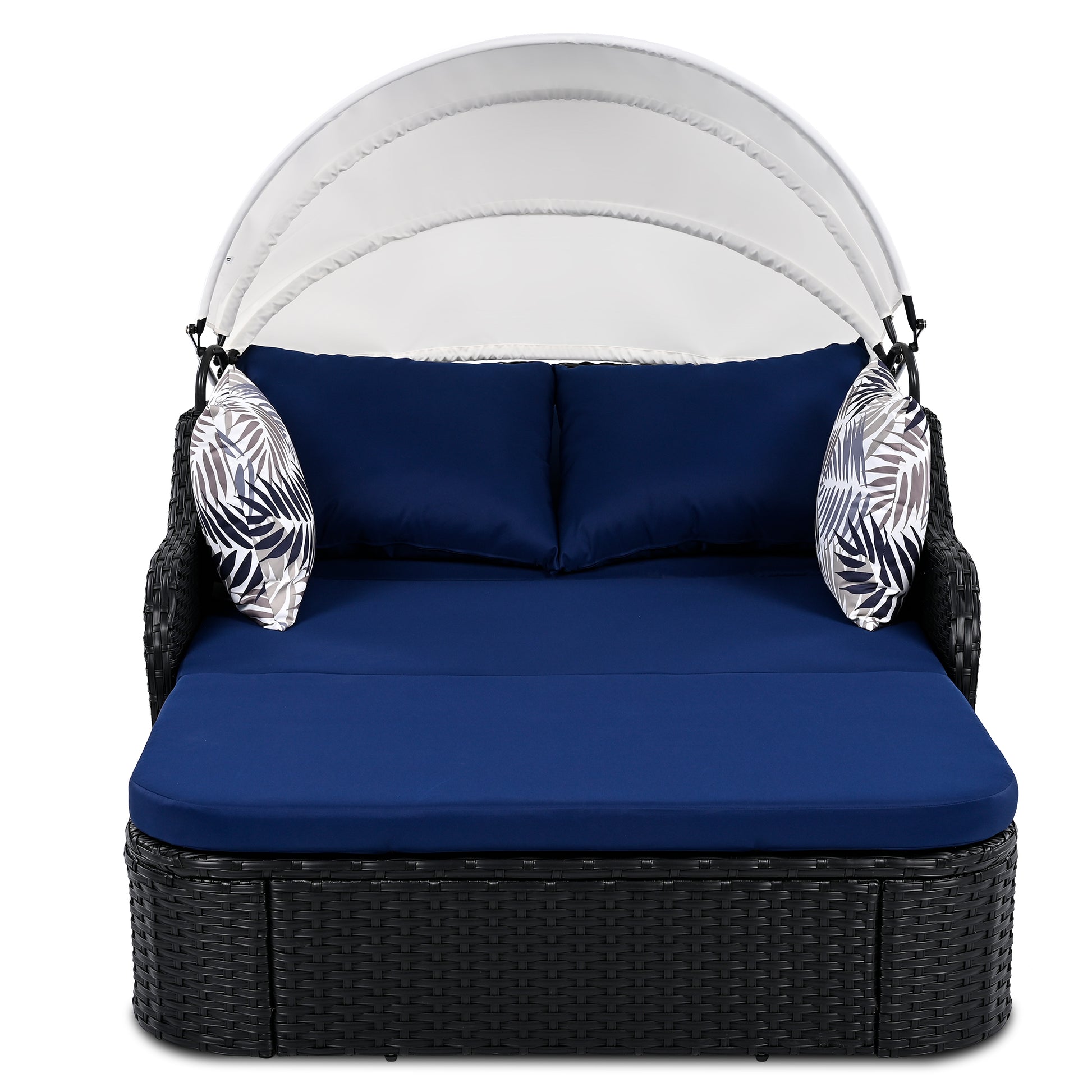 Black rattan outdoor daybed with navy blue cushions and white canopy