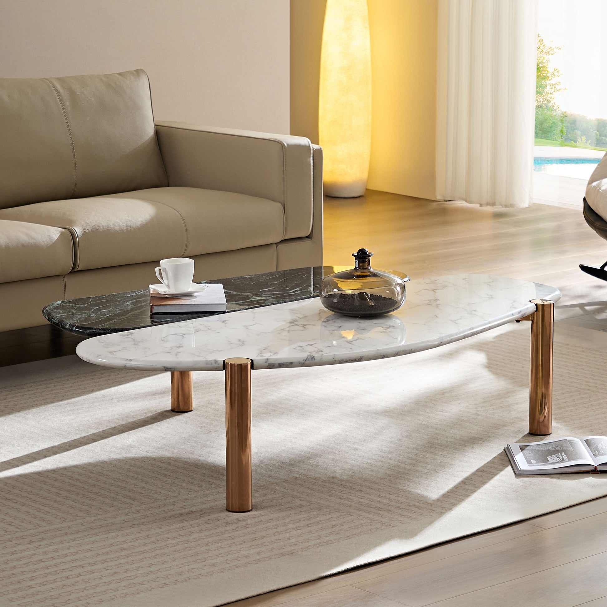 Modern oval coffee table with white marble top and dark green inlay brass legs