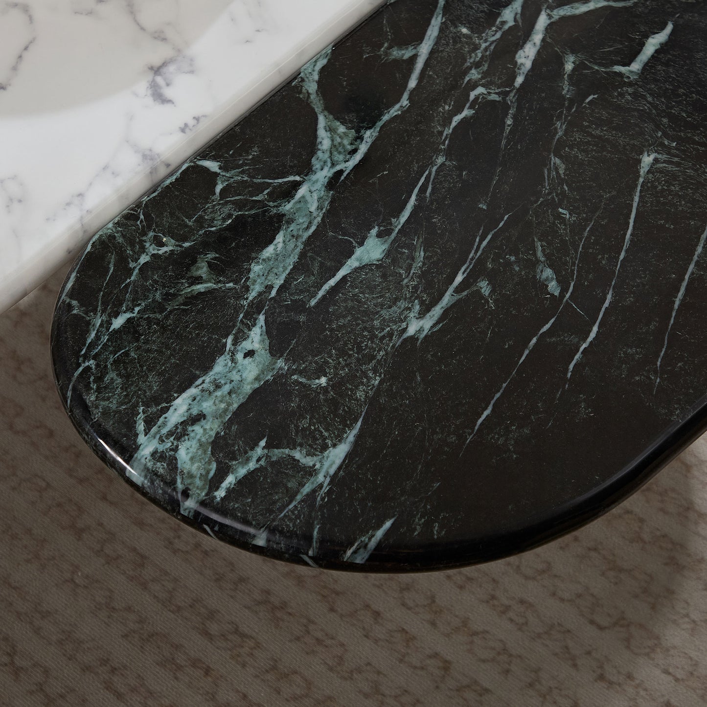 Dark green marble tabletop with white veining showcasing its luxurious texture