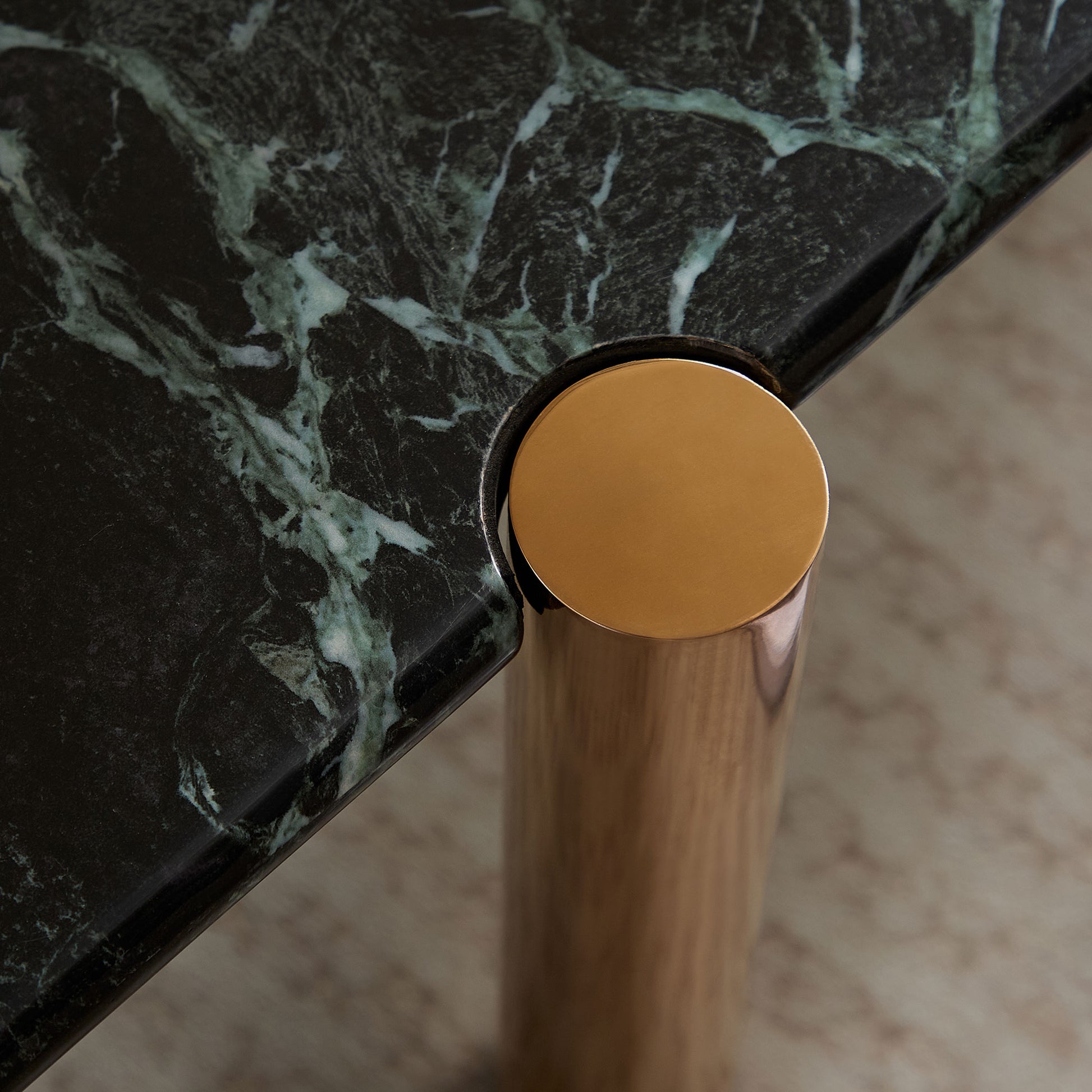 Green marble tabletop with polished brass leg detail