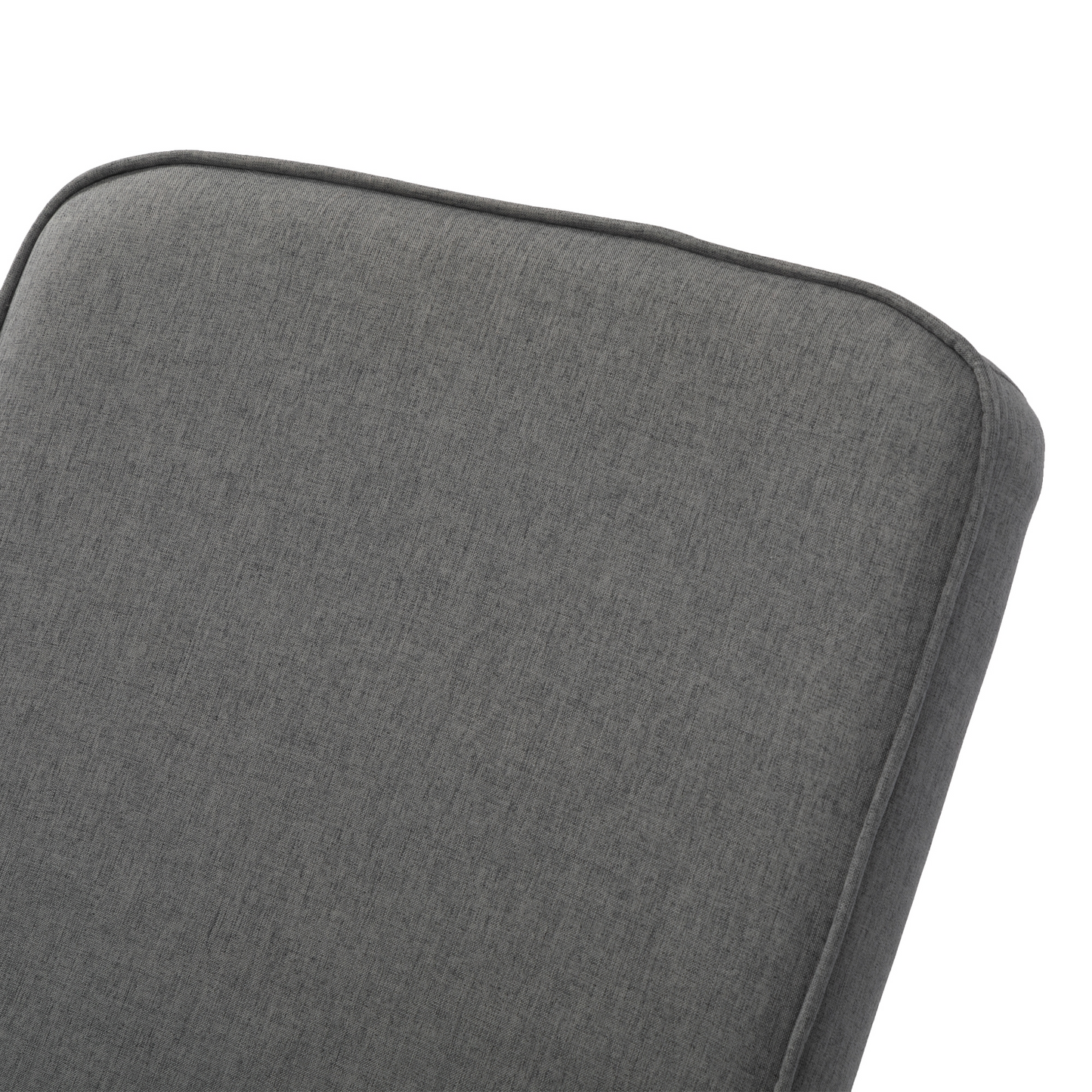 Closeup of textured dark gray upholstered headboard with piping detail